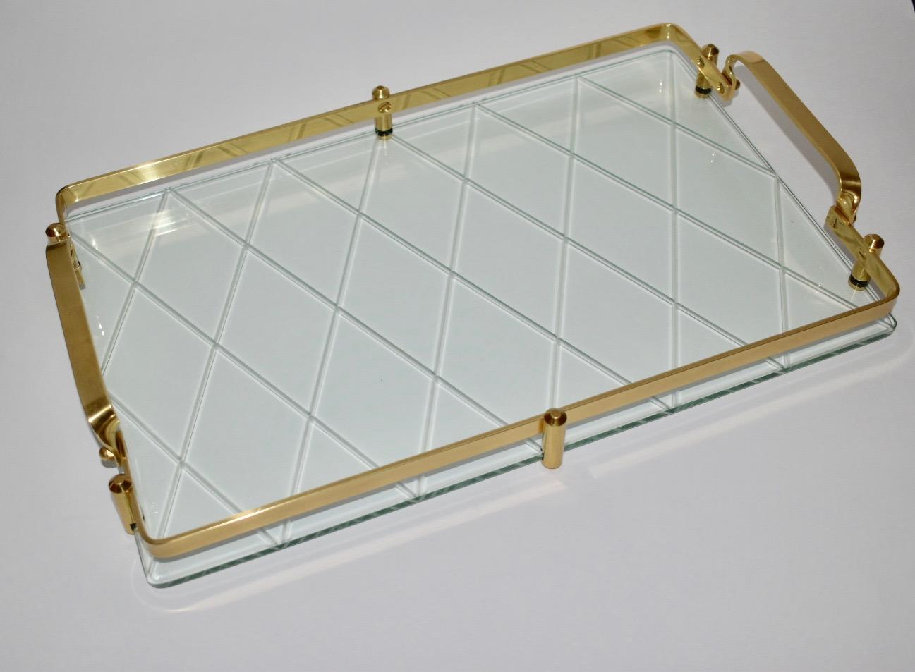 Stunning glass vanity tray with diamond or cross hatch motif with stylized brass gallery rails and handles in the style of Pietro Chiesa for Fontana Arte or Tommi Parzinger. The pattern to the back of glass was cut with a copper wheel with very fine