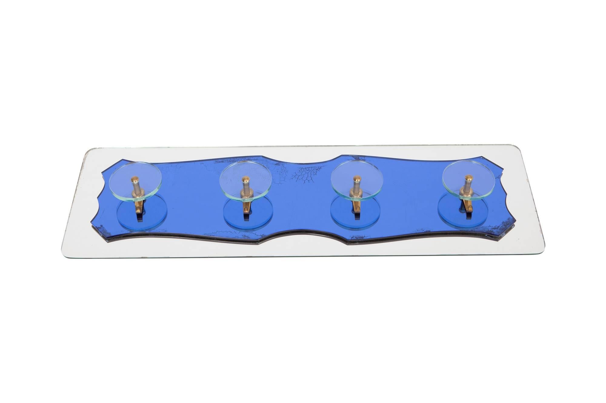 Mid-century modern Rectangular coatrack in Fontana Arte style, Italy, 1970s. Mirrored and blue colored glass that is cut out in an interesting shaped. 
The Blue glass shows some panting which give it an characteristic look. The four round shaped