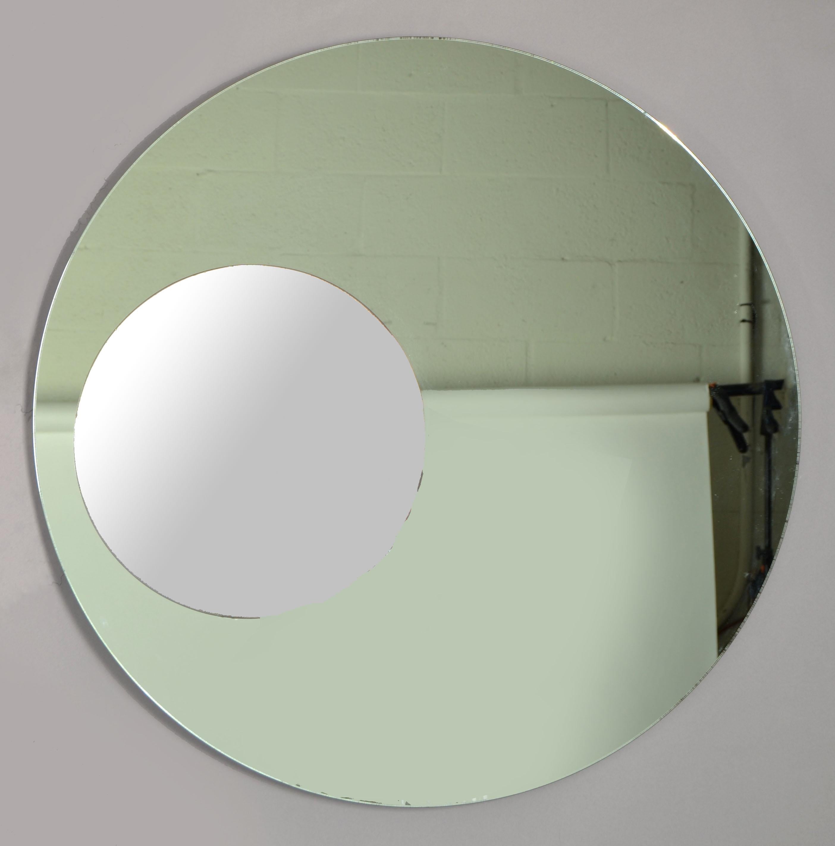Fontana Arte Style round double Glass Wall Mirror, no Frame with wooden backing.
Italian Mid-Century Modern Period made in the late 1970s.
Two tone colored mirror glass on a wooden backing.
Overall, a Classic design with the flair from Italy.
No