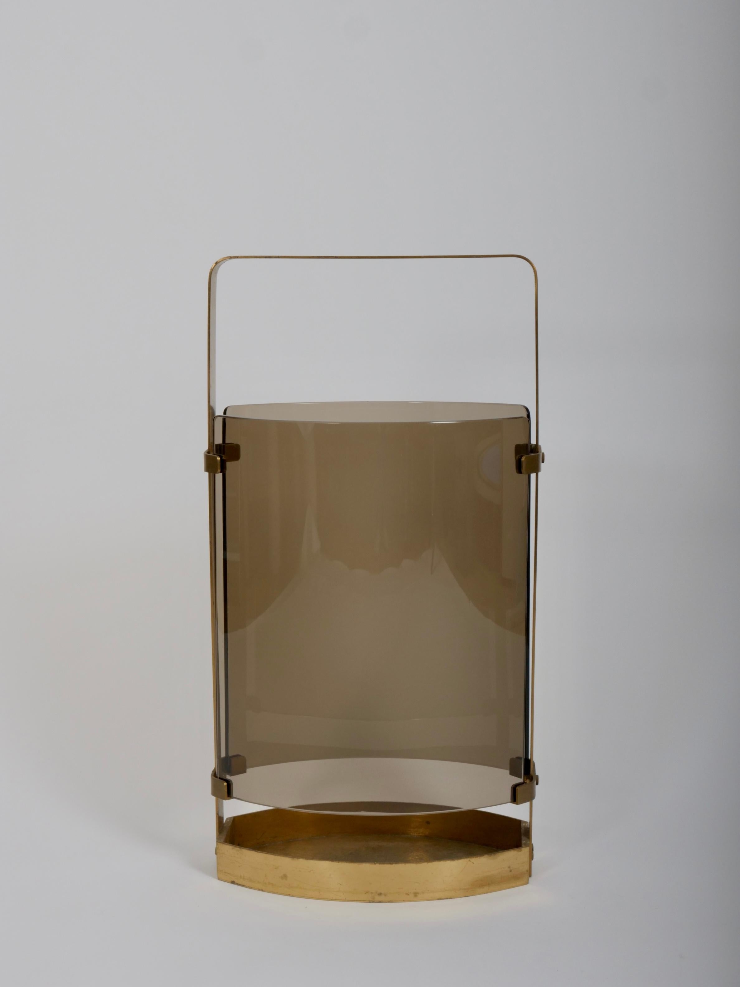 An elegant umbrella stand by Max Ingrand for Fontna Arte

Curved smokey glass with brass

In very good condition. Nice patina to the brass. 

Glass is all good. No nicks or chips