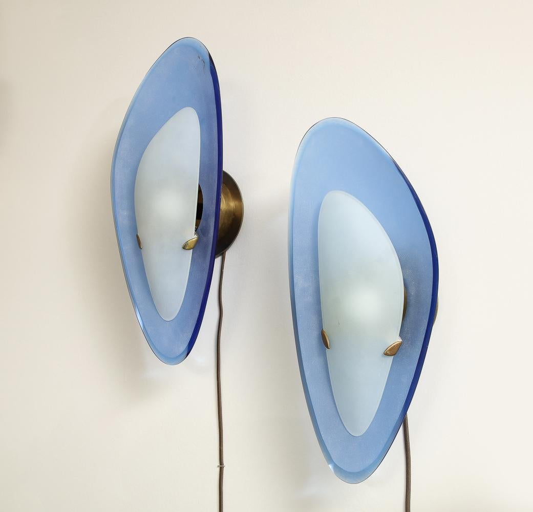 Rare Pair of Sconces by Fontana Arte.  Blue colored glass, acid-etched glass, brass. Each sconce takes 1 x E12 (candelabra) bulb.