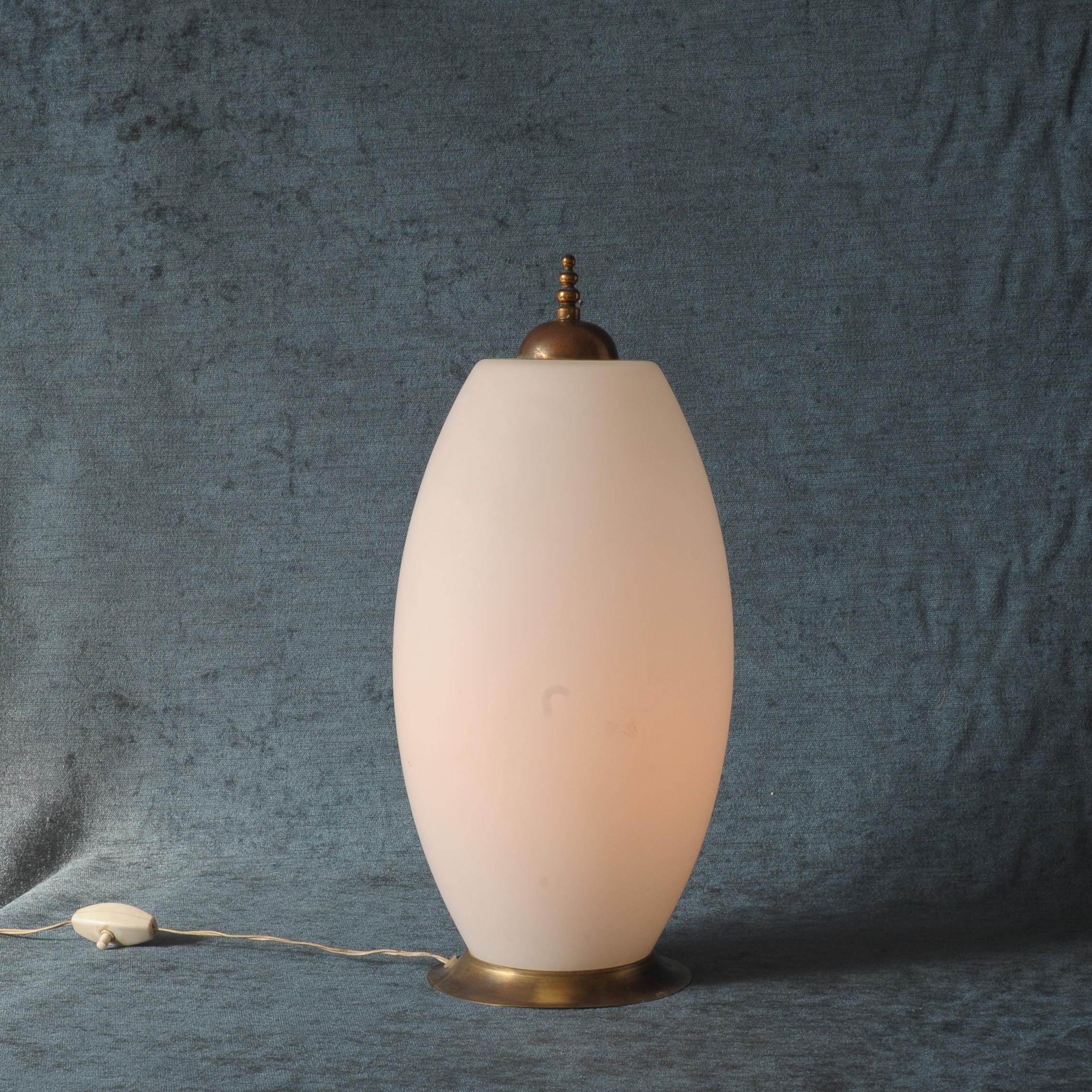 This sophisticated lighting piece was produced in the beginning of the 1940s in Italy by Fontana Arte.
The white milk glass gives you a soft, warm light.
The fine brass details make the piece unique. All parts are original!.
 