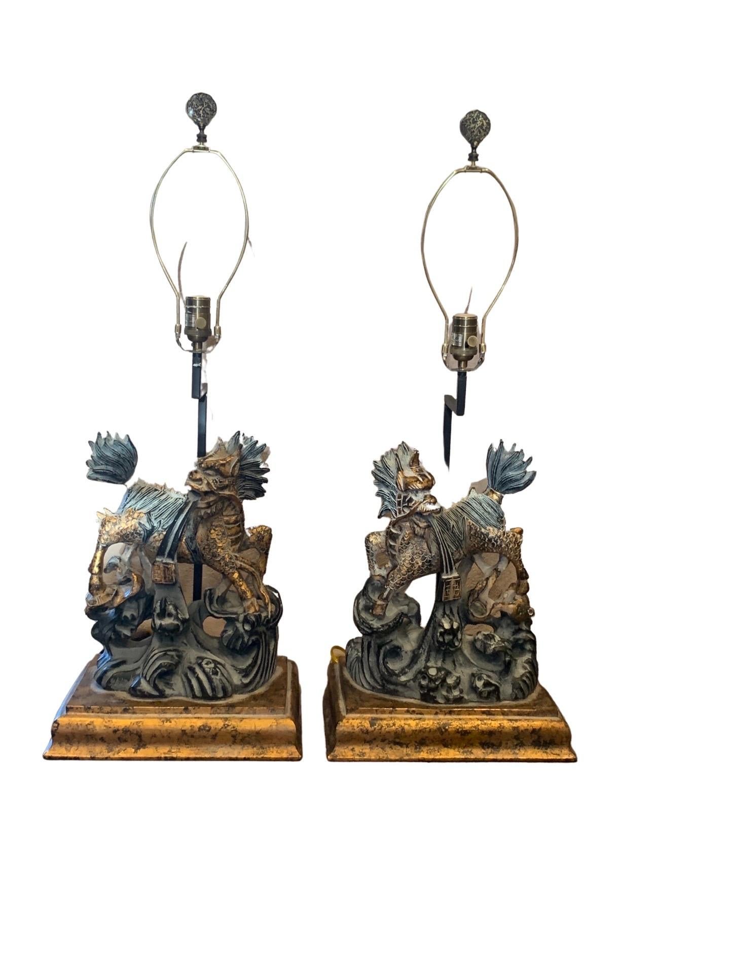 These beautiful pair of large Foo dog lamps are a matching left and right pair. They are hand-painted and faux finished to look antiqued. The dogs in black and gold are highlighted with gray. Designer purchased for a very upscale luxe home in Palm