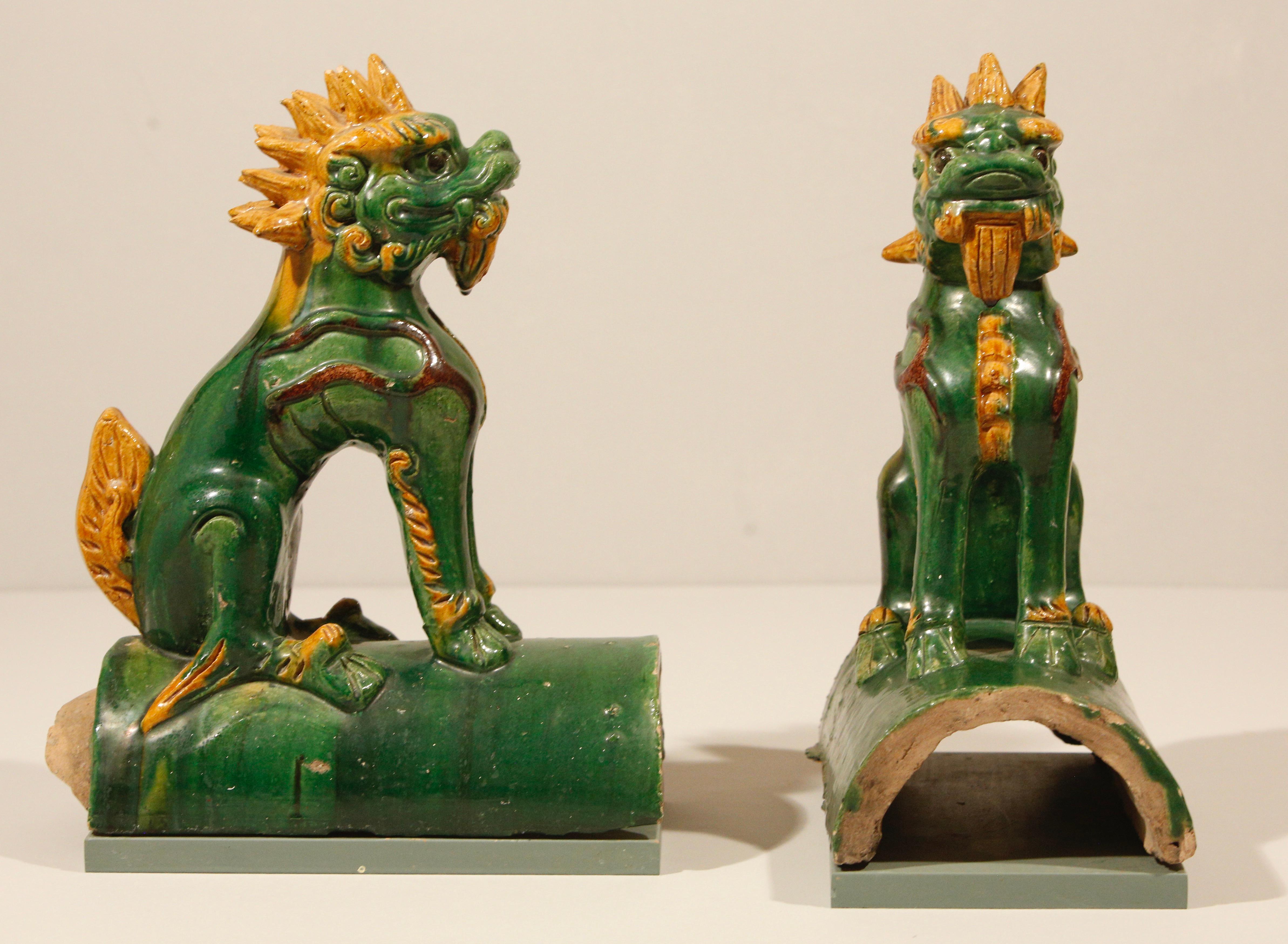 Foo Dogs Chinese sancai architectural roof tiles in green and mustard / orange shades.

Les anciennes statues chinoises de lions gardiens (également connues sous le nom de 