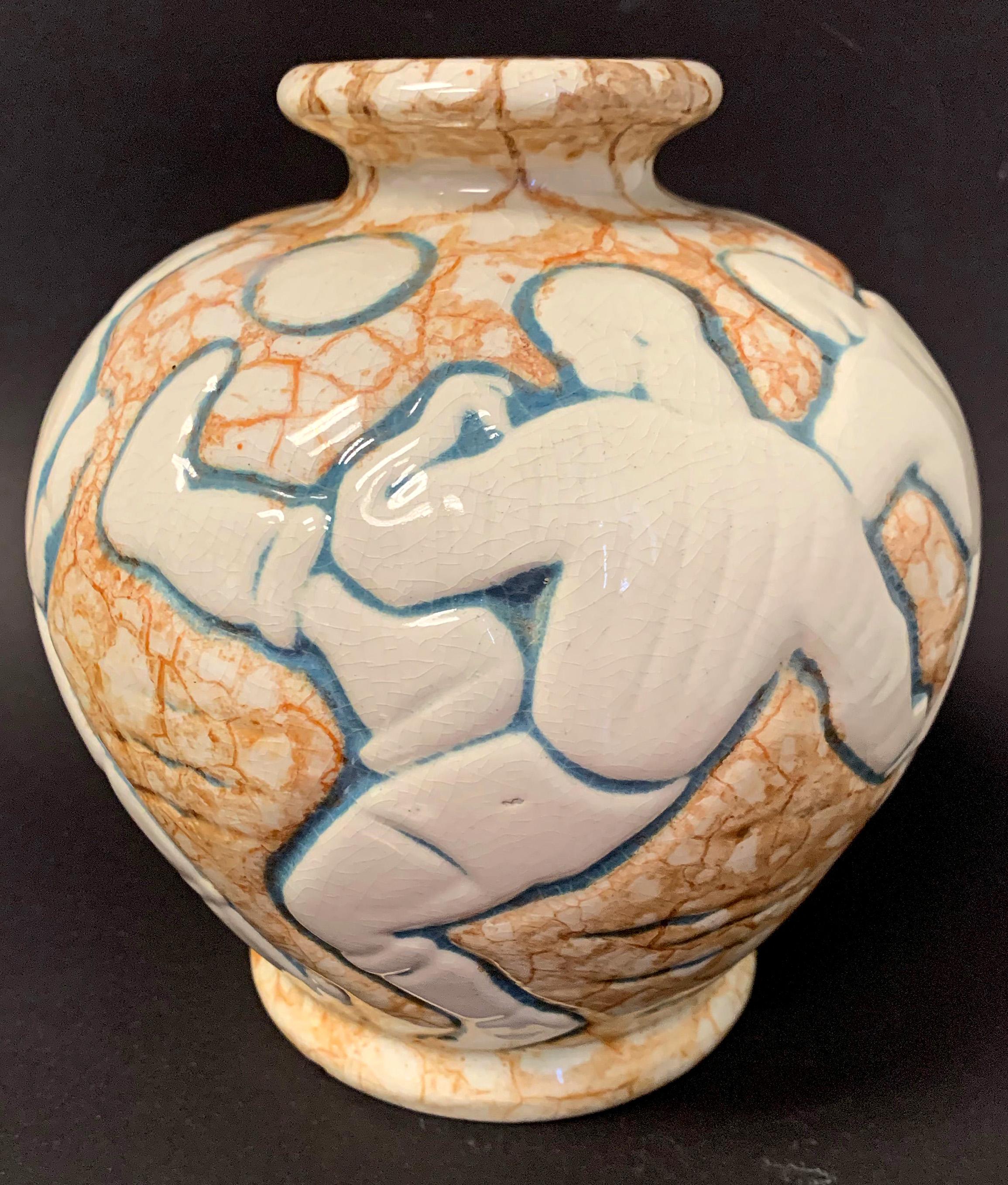 Very rare and full of energy, this Art Deco vase depicts a frieze of six football or soccer players in the midst of the game, the ball in the air and very much in play. This piece was designed by André Legrand for Mougin Frères Nancy, a renowned