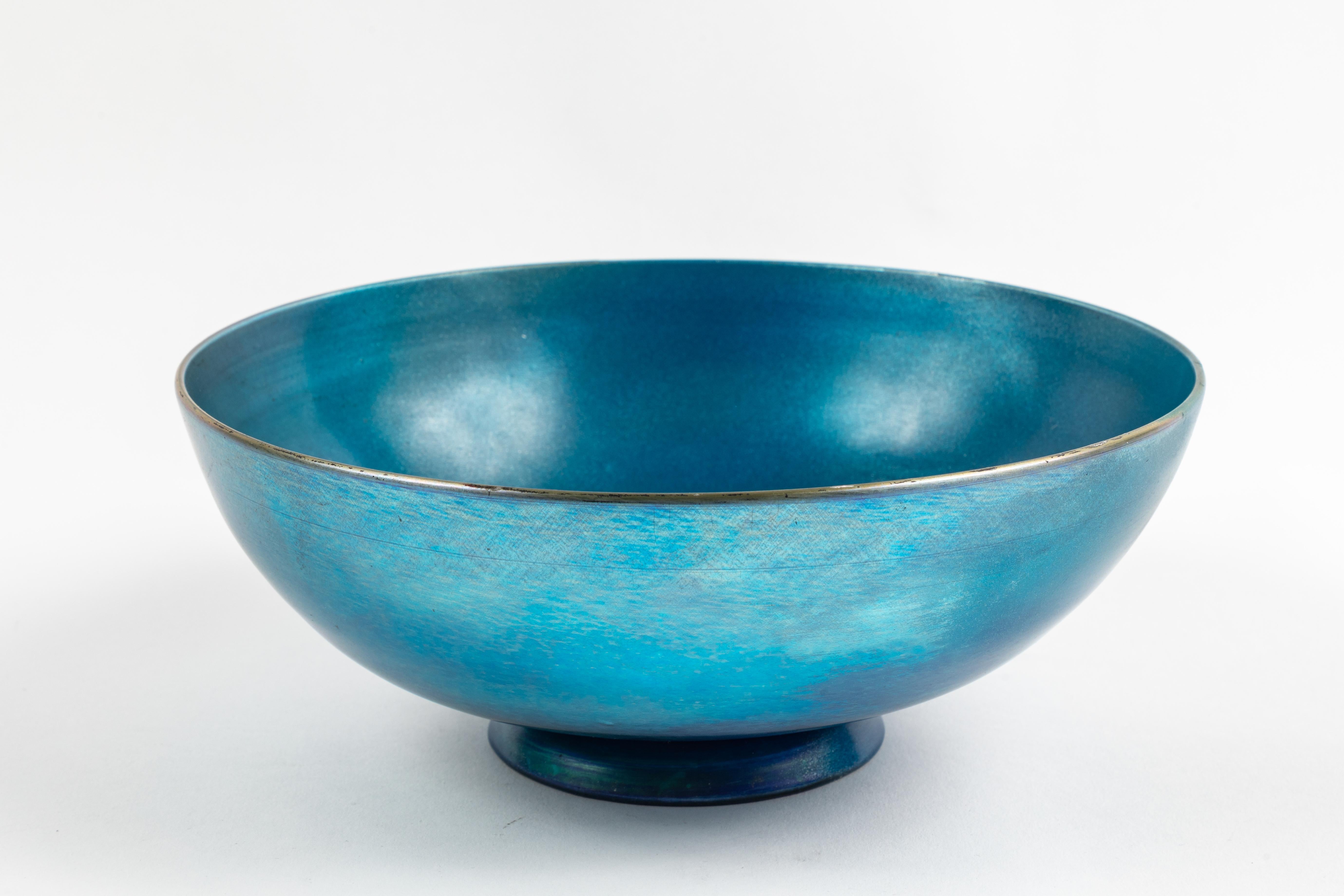 This vivid iridescent blue bowl designed by Frederick Carder for Steuben from the Aurene series of glass is a real stunner. Set on a graceful foot the bowl is signed 