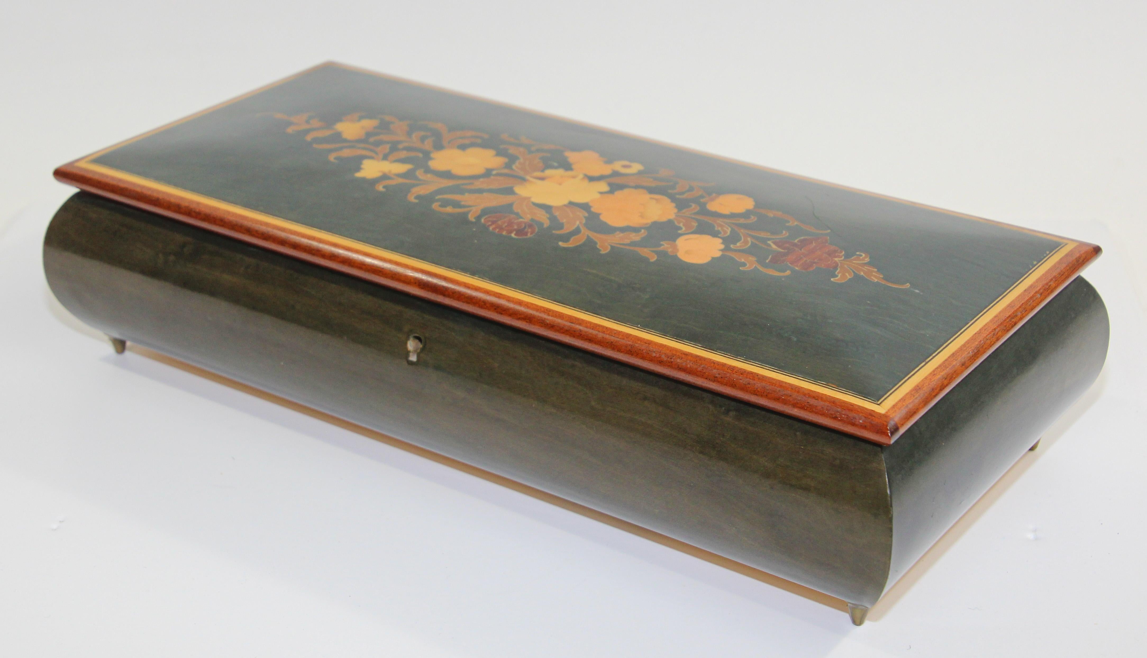 Elegant large footed blue color wooden music box with top finely hand painted and inlaid with foliages floral decor.
Upon opening, the music box begins to play 