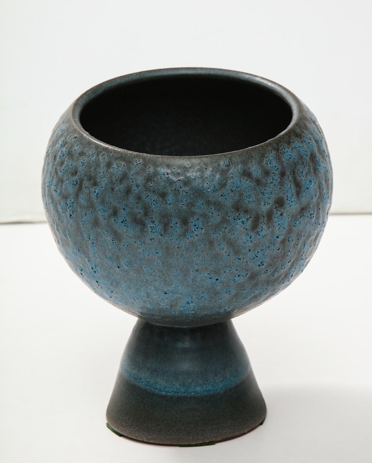 Cone-shaped foot and cut-orb bowl. Both pieces wheel-thrown, and bubbly blue glaze. Artist signed on underside.