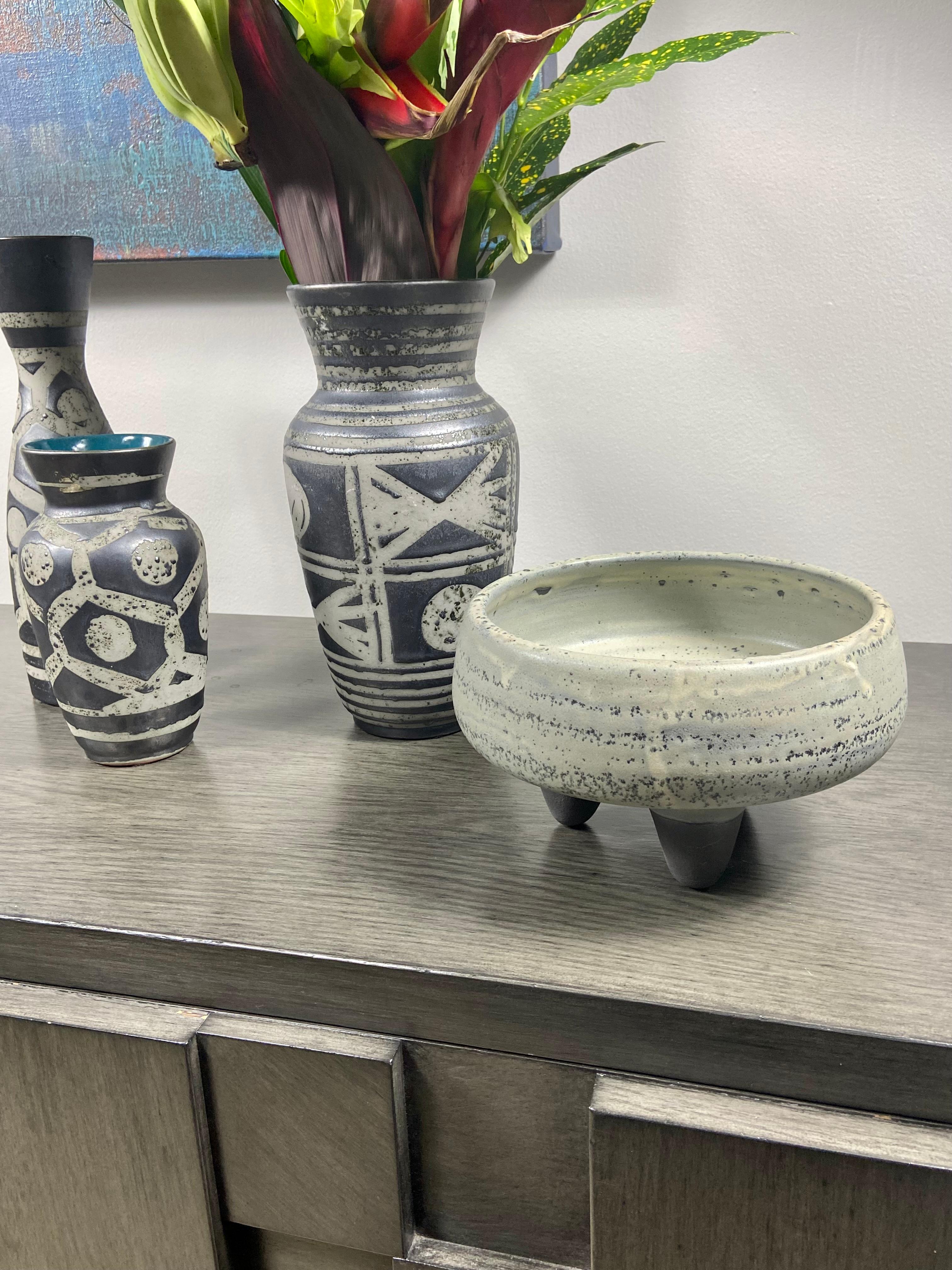 A ceramic speckled 3-footed Mid-Cenrury inspired succulent planter or bowl. It has a beautiful mottled glaze in a sage/gray tone with charcoal glazed matte feet. It can be used as a fruit bowl and is food safe.