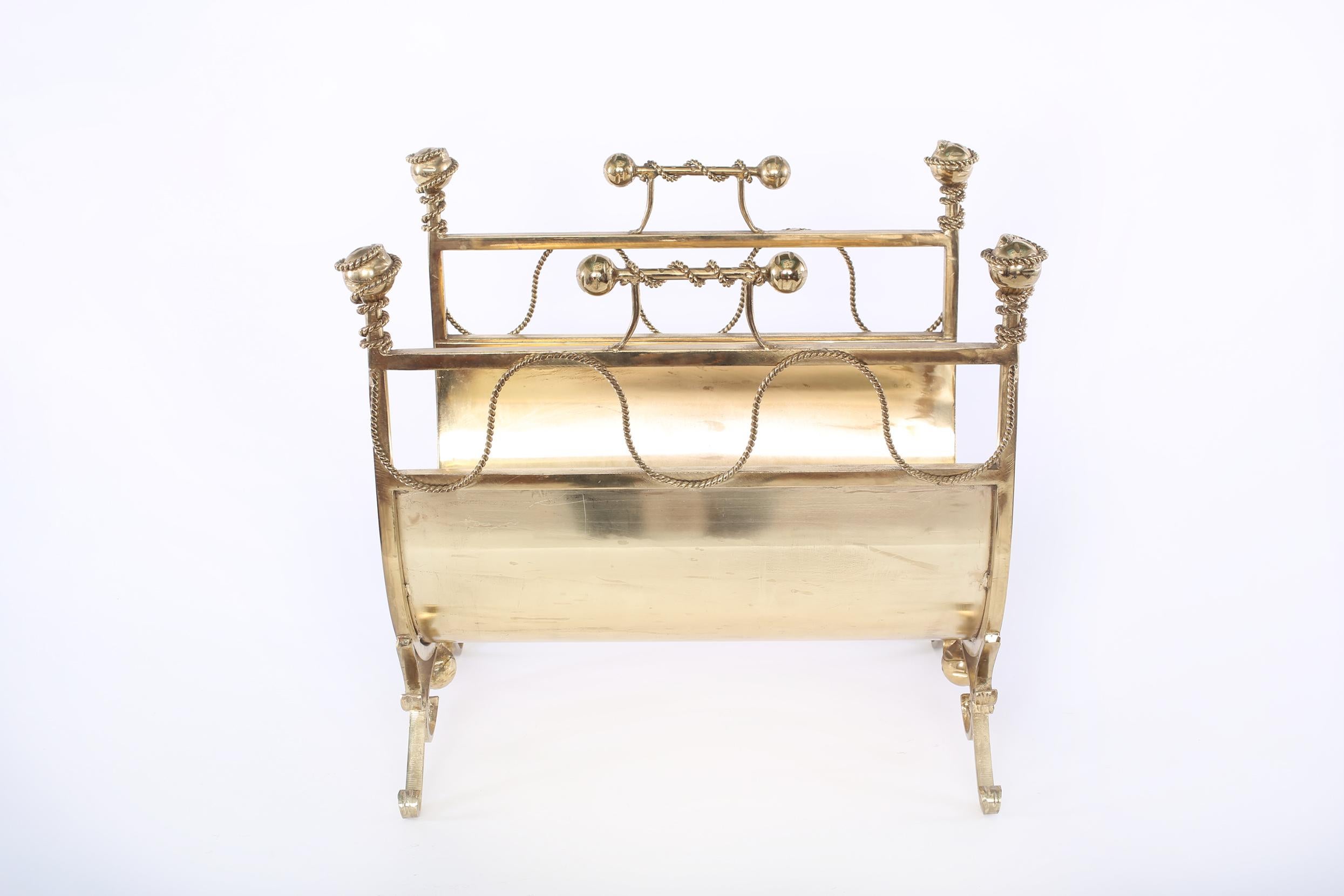 Italian footed solid brass fire logs holder with top handles & exterior design details. The logs holder stand about 17 inches high x 13 inches deep x 19 inches wide.