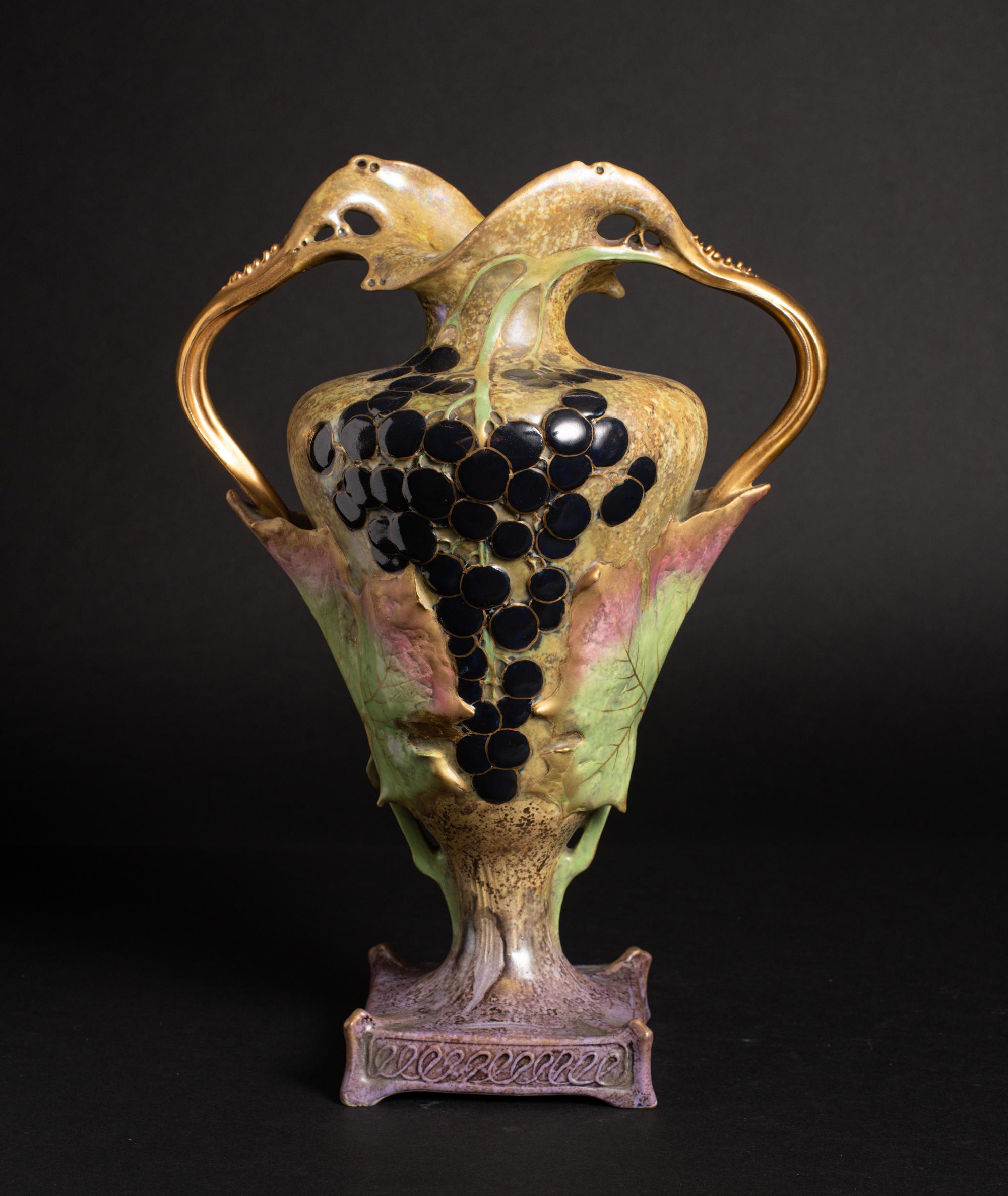 Model #3425

Highly stylized vase with grape vine motif and secessionist handles.

Paul Dachsel was the son-in-law of Alfred Stellmacher, the founder of Amphora Pottery company in Turn-Teplitz, then in Austria. Very little is known or was written