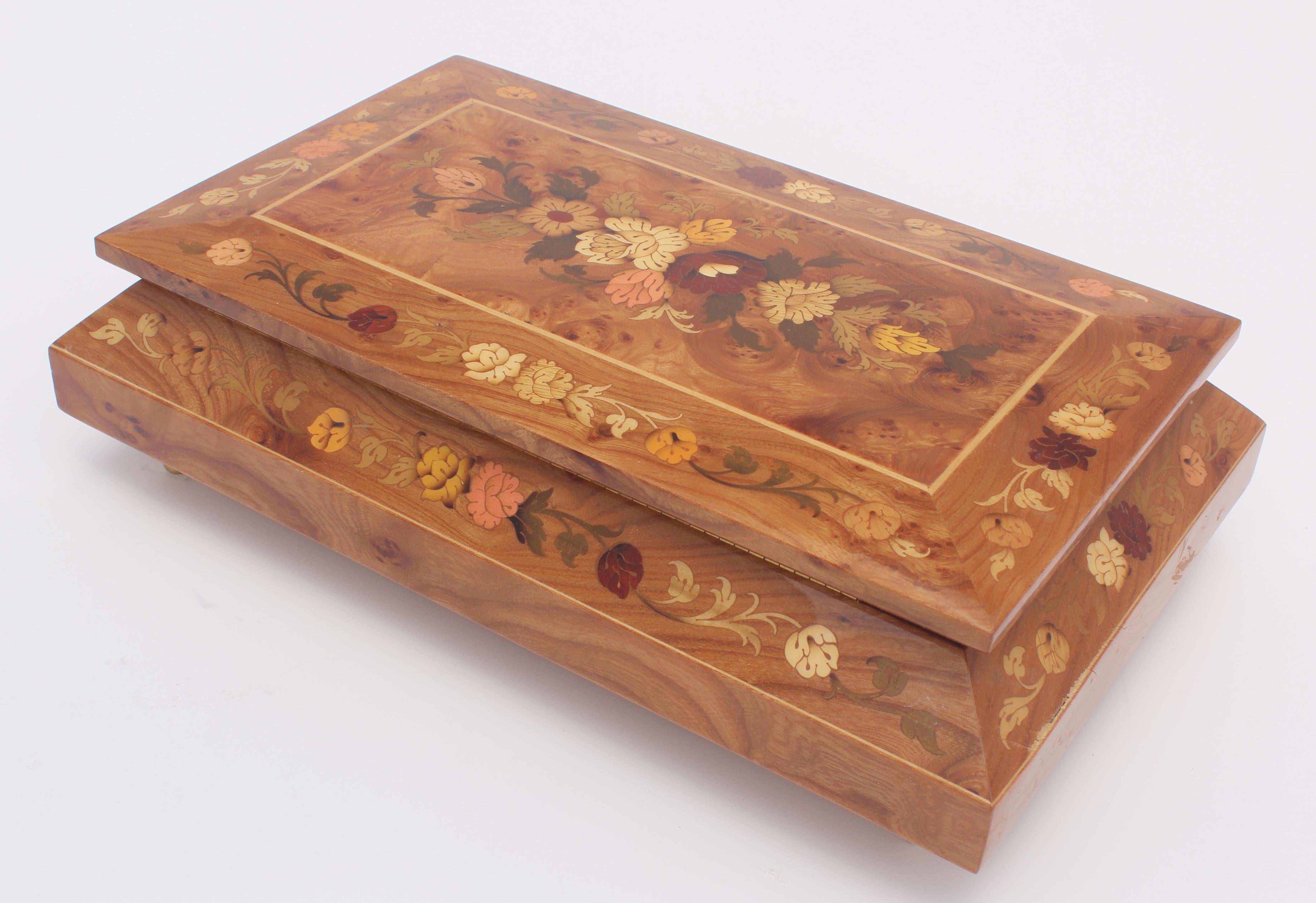 Elegant large footed wooden music box with top finely hand painted with foliages.
Upon opening, the music box begins to play 