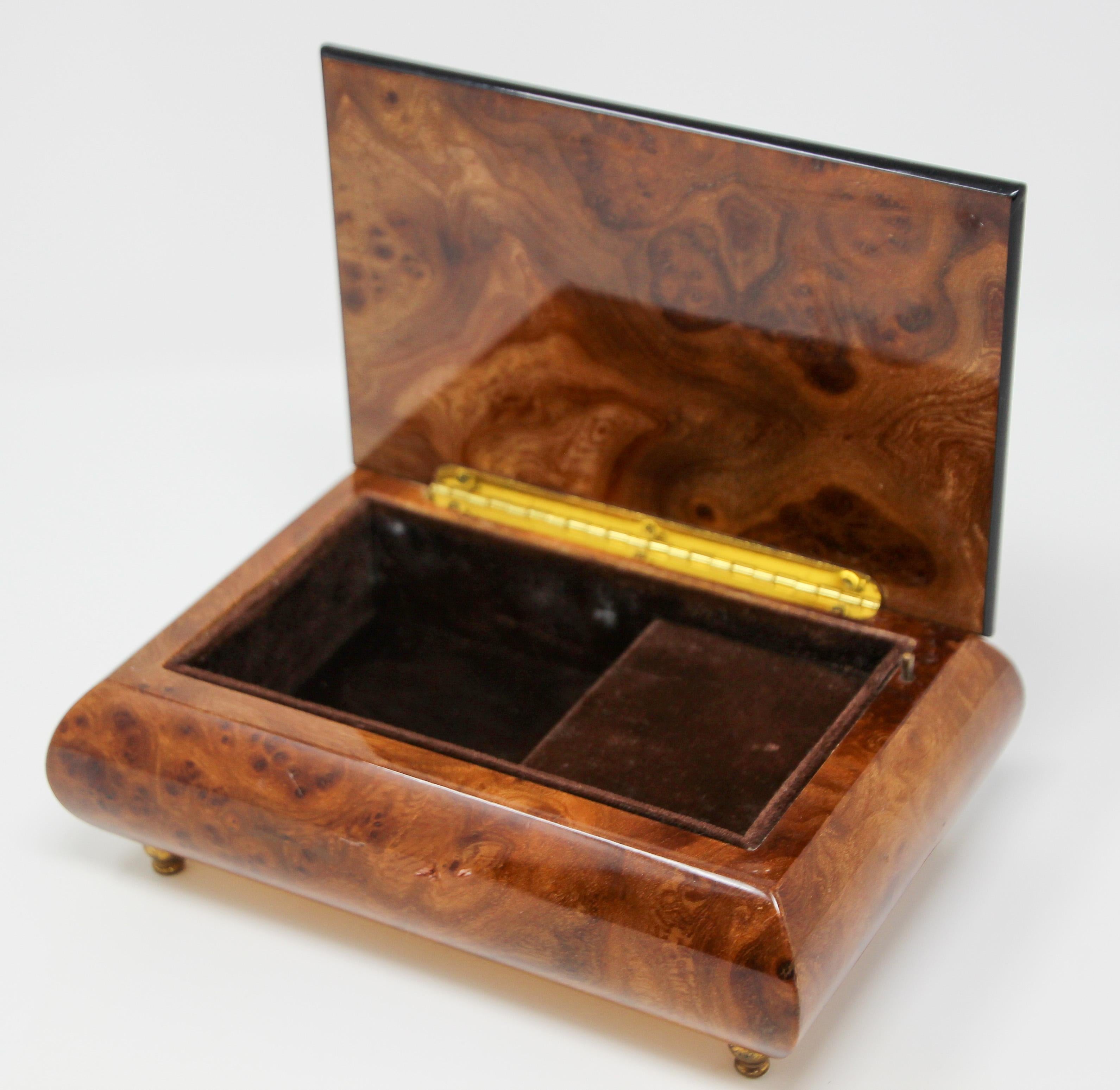 Elegant footed wooden music box in thuya wood.
Thuya tree is famous for rich gold and brown shades of its grain and unique exotic fragrance, similar to cedar.
Upon opening, the music box begins to play 