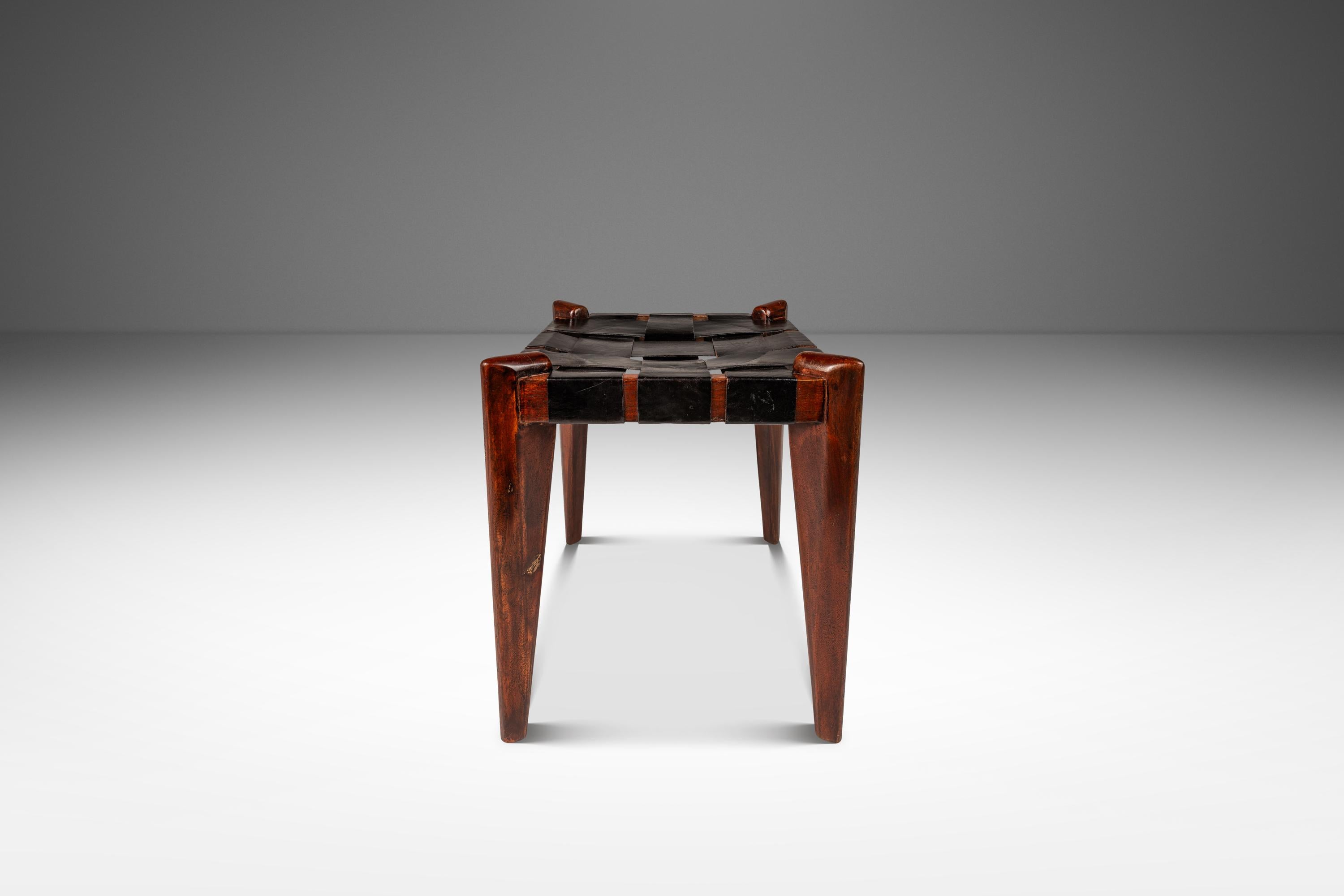 This elegant Mid-Century Modern stool by Edmond J. Spence captures the organic sophistication of 1950s design. Constructed in rich teak, the stool features a warm, tastefully aged patina that enhances the wood’s natural grain, complemented by angled
