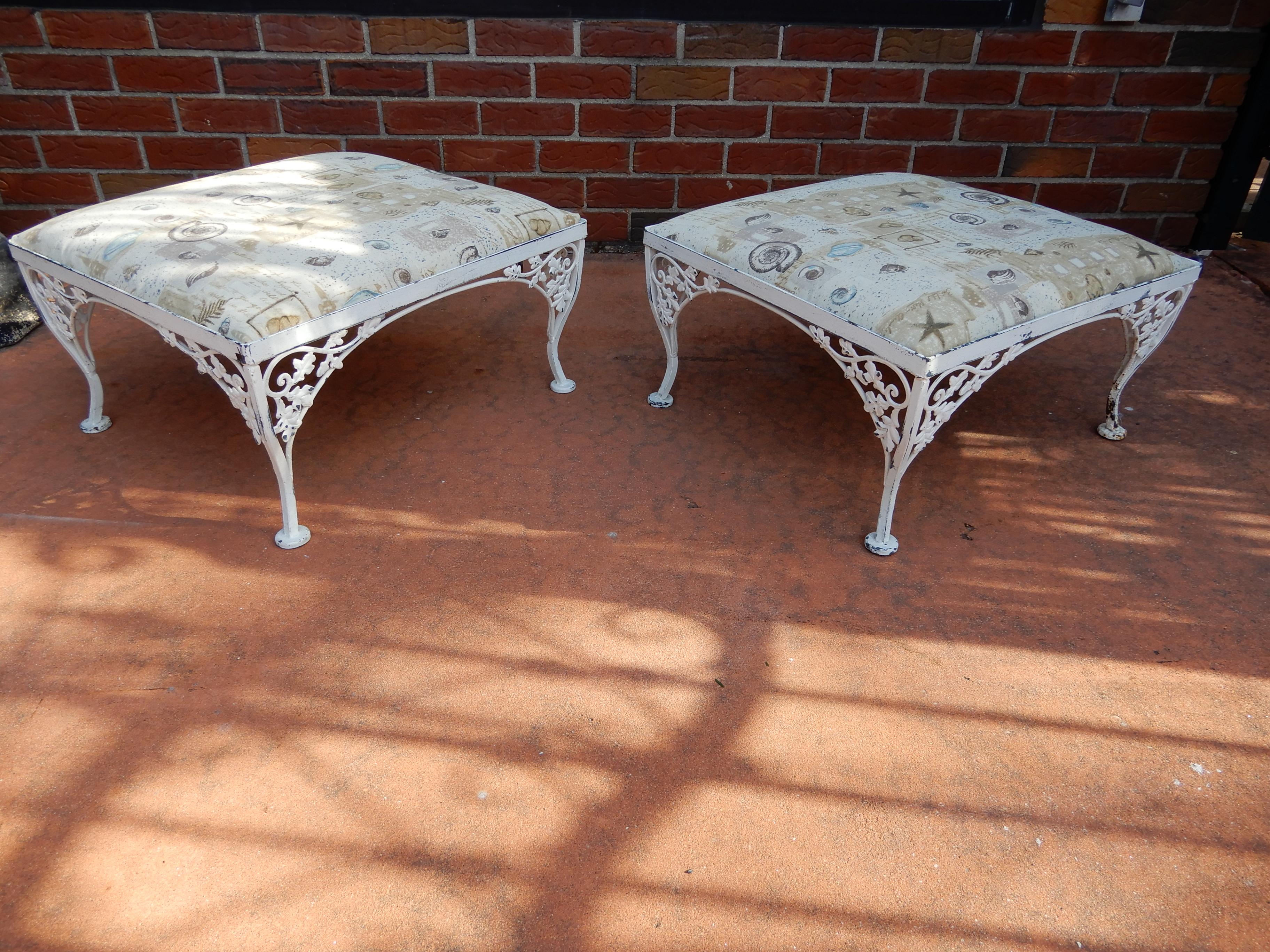 A pair of wrought iron footstools by Woodard Mfg co. In the Orleans pattern, showing details of acorns and leaves
The white painted finish is worn and is as found. Pairs of footstools are rarely found in wrought iron.