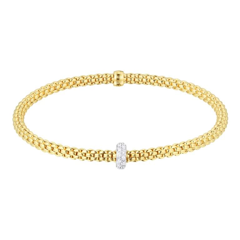 This stunning bracelet is part of the Fope Prima collection and features a finely crafted 18ct yellow gold Flex'it stretch design. The bracelet features a single rondelle in 18ct white gold, pave set with 0.18cts of sparkling brilliant cut diamonds.