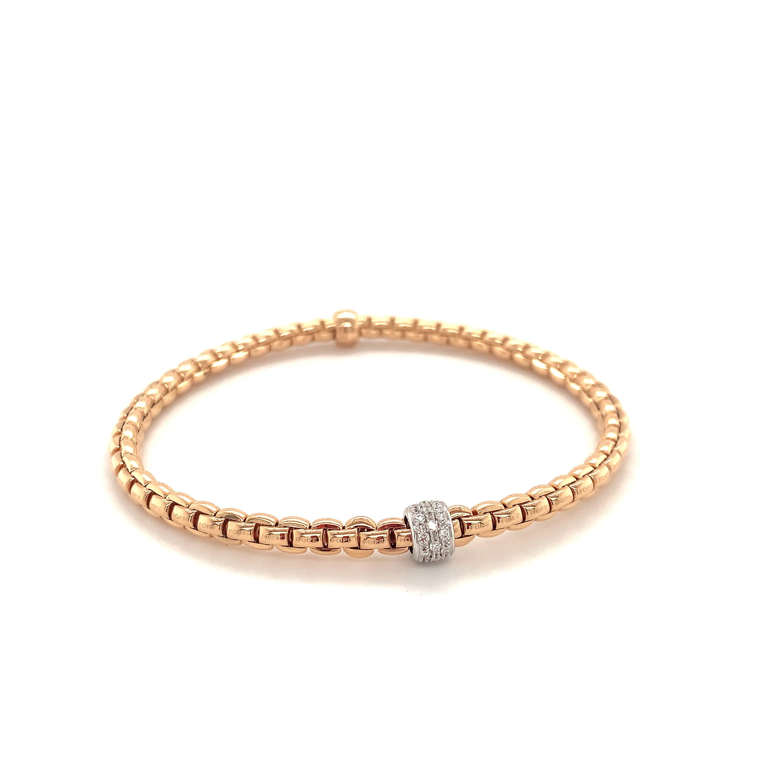 Flexible bracelet entirely made of 18 karats rose gold with white gold rondel (0.19 carats of diamonds). This mesh chain hides dozens of tiny 18 carat gold springs which make the bracelets and rings smooth and flexible. The bracelet diameter can be