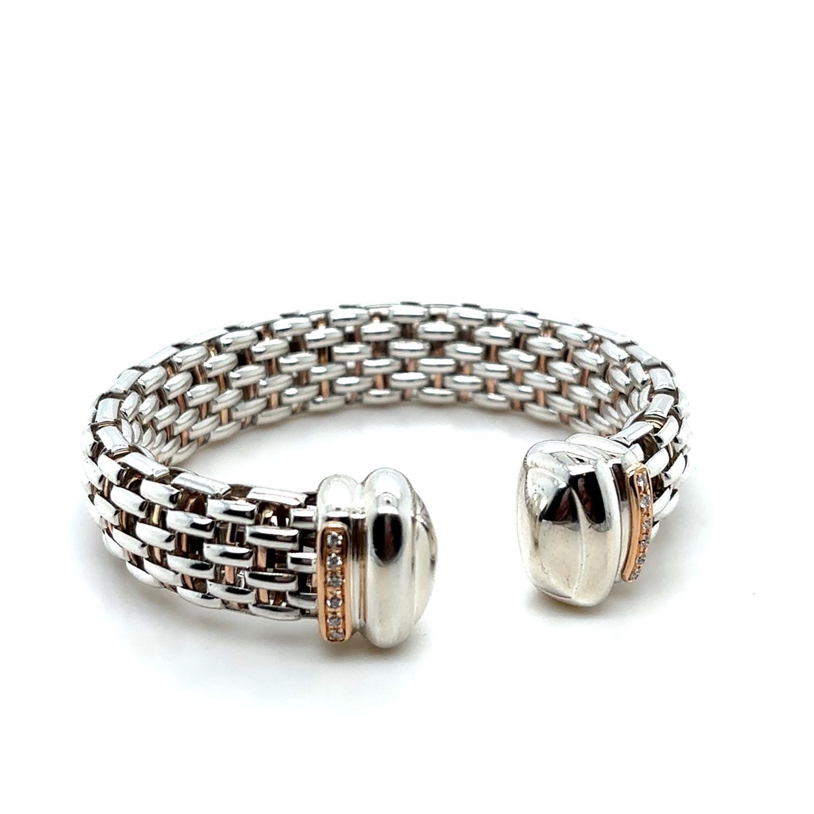 A Fope Italy diamond, silver and palladium cuff.

This elegant cuff is crafted in silver and palladium, detailed with round brilliant cut diamonds set to either end in contrasting rose gold vermeil, which is also weaved through the body of the
