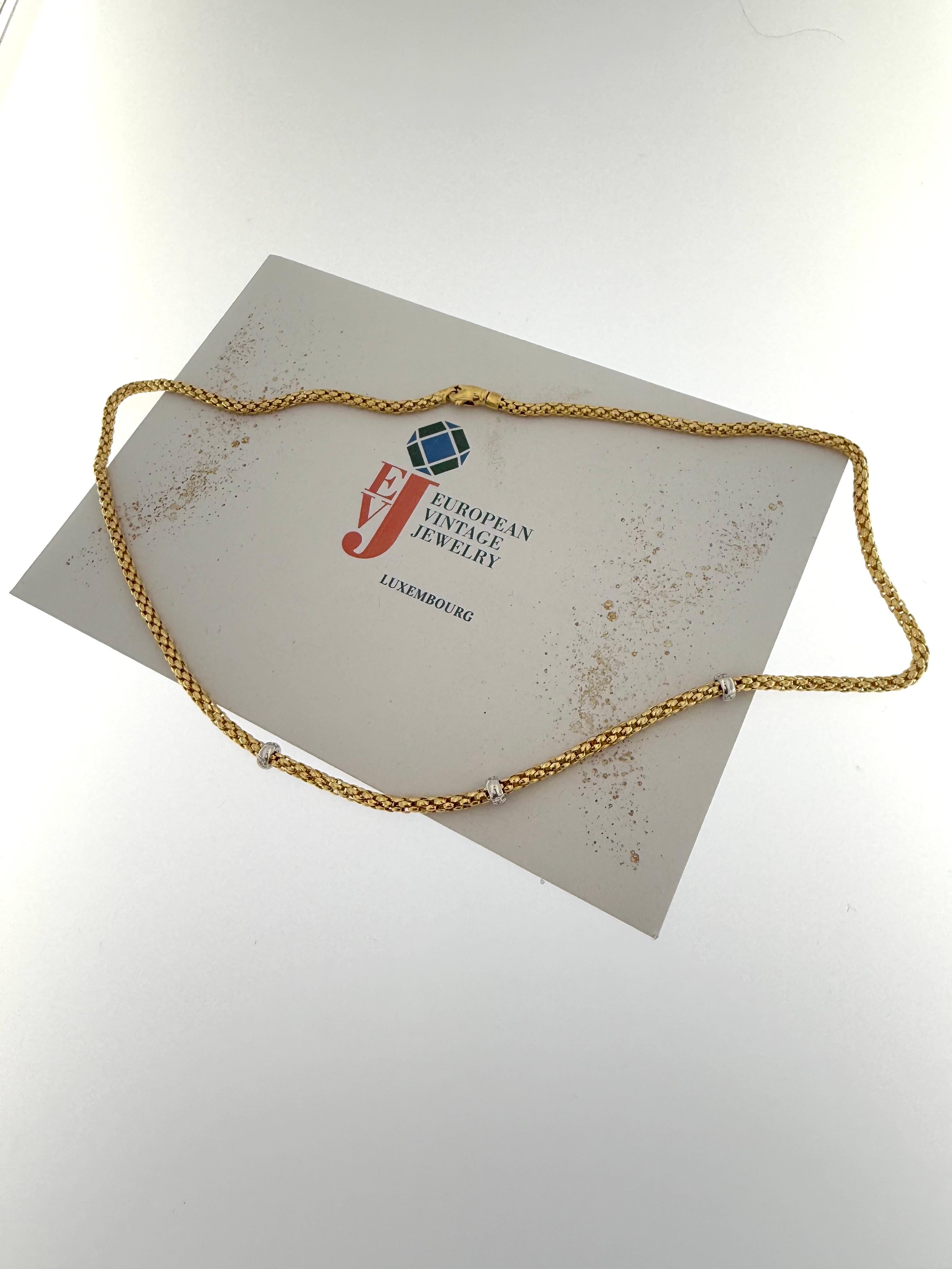 This exquisite Fope Yellow and White Gold Necklace is a perfect blend of timeless elegance and contemporary Italian craftsmanship. Expertly crafted in 18kt gold, the necklace seamlessly combines the warmth of yellow gold with the sleek