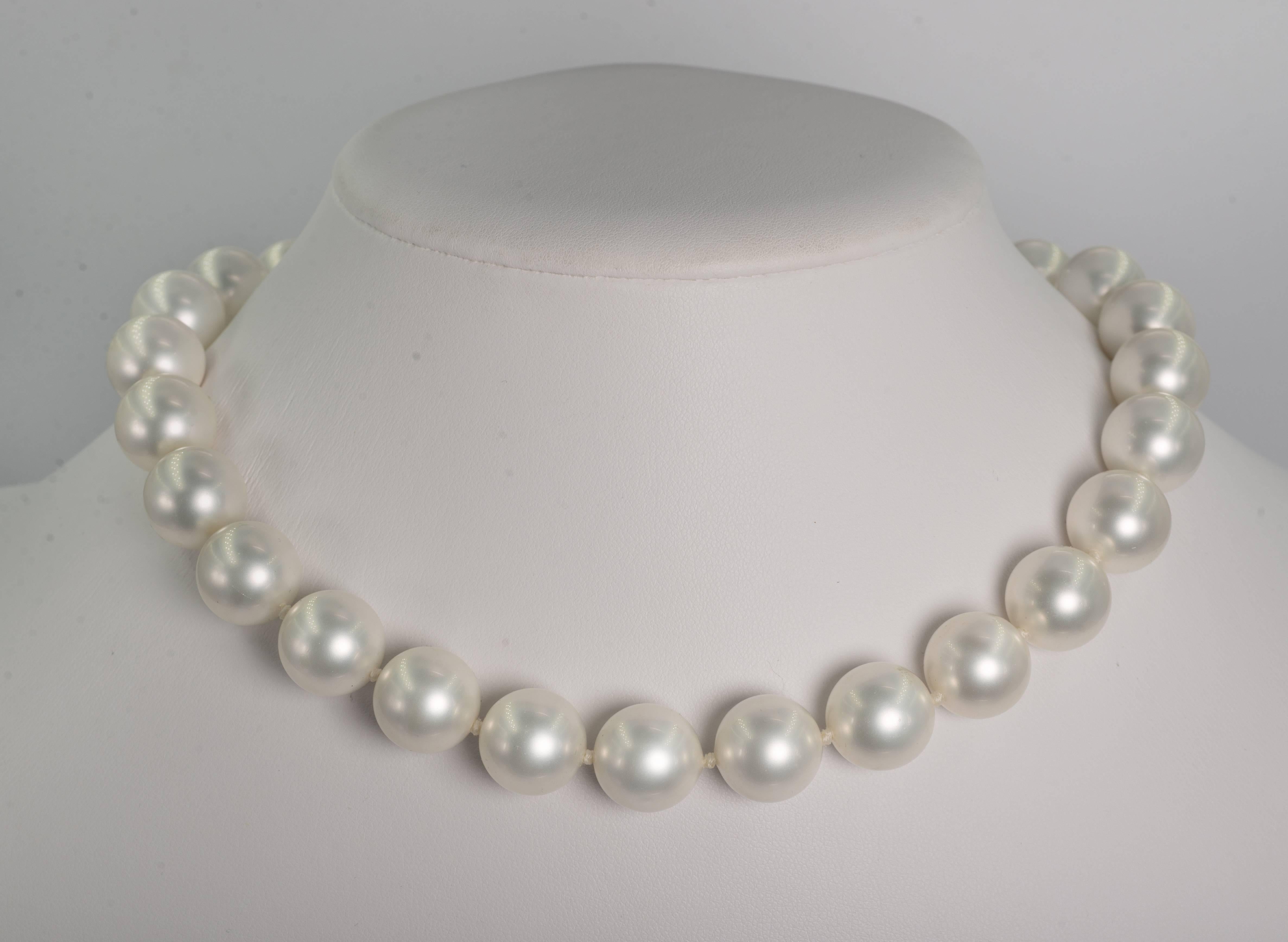 Faux 16mm South Sea Pearl Necklace measuring 18'' to a gilt pave cubic zirconia clasp. The pearls are made of mother of pearl and have a wonderful luminescent pearl coating. Freshly hand-strung knotted with silk threads.