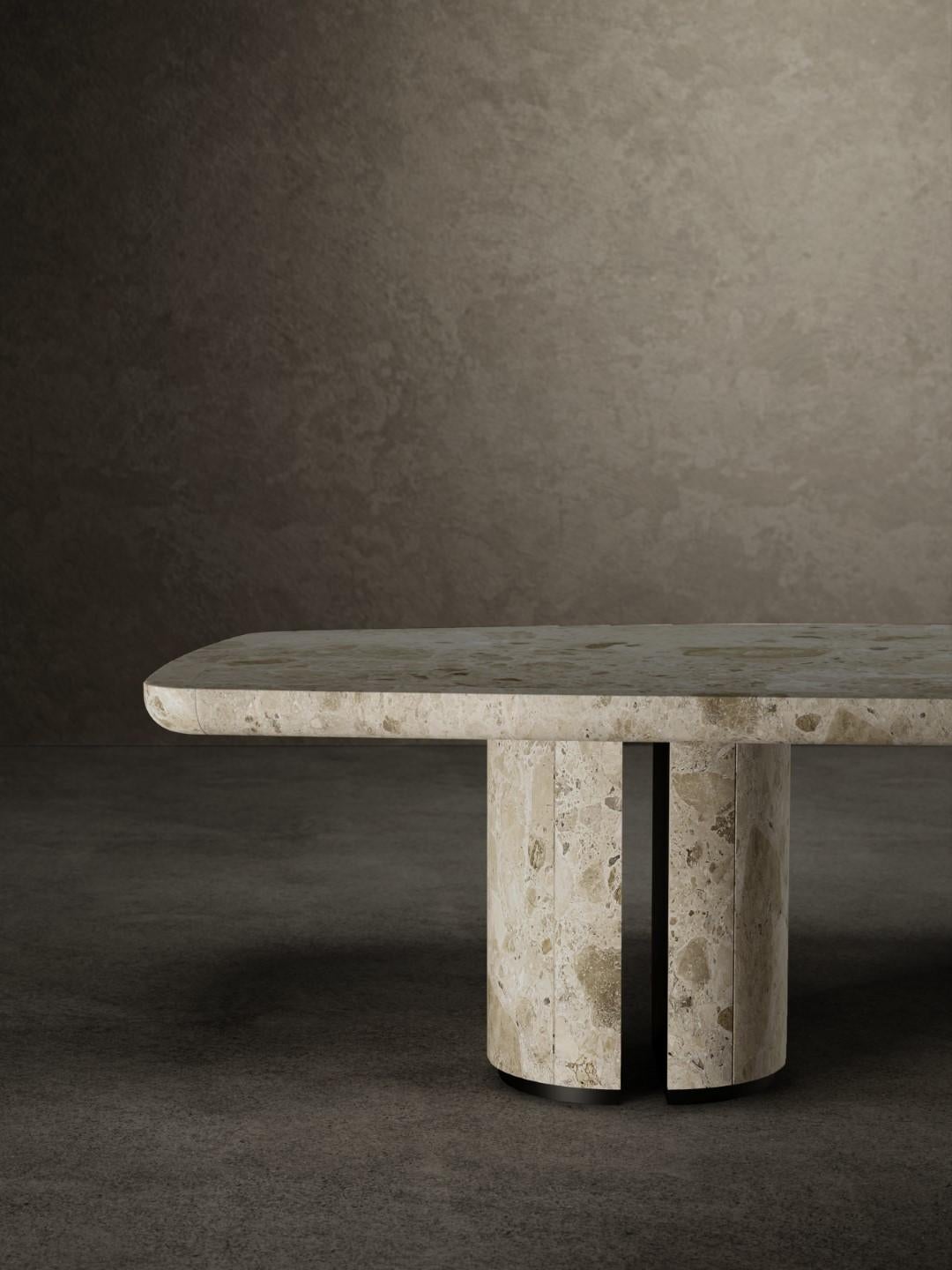 For No One dining table has a top made up of a supported Ambrosia matt marble slab with an 8 cm frame in solid marble.
The top is anchored to the two bases by matt black metal plates. Each base is made up of two half-cylinders in matt-finishing