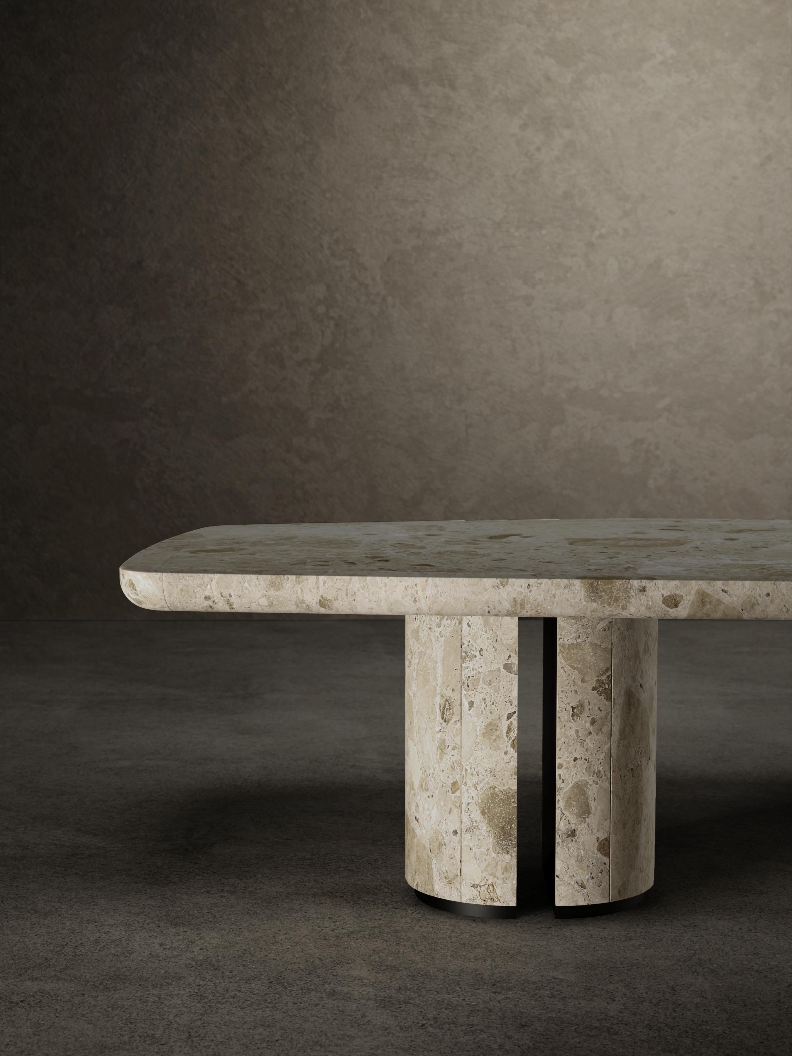 For No One dining table has a top made up of a supported matte Ambrosia marble slab with a solid marble frame.
The top is anchored to the two bases by matte black metal plates. Each base is made up of two half-cylinders in
matt-finishing Ambrosia