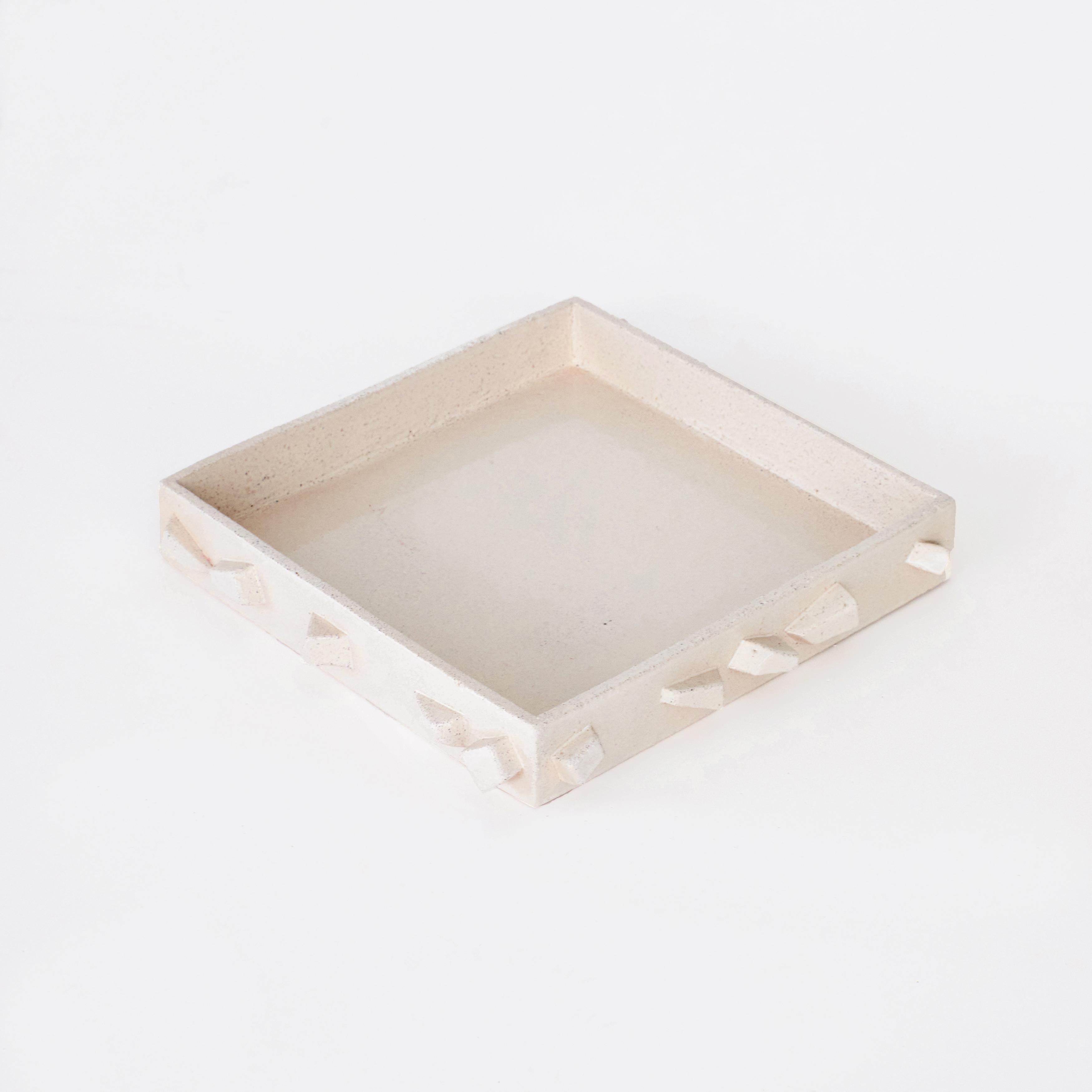 'For Rachel' tray in Cream

Hand-sculpted ceramic tray with hand made rectangle shaped elements. This large sized tray is finished with a bespoke cream glaze that reveals the natural grain of the clay beneath and is hallmarked with Project 213A