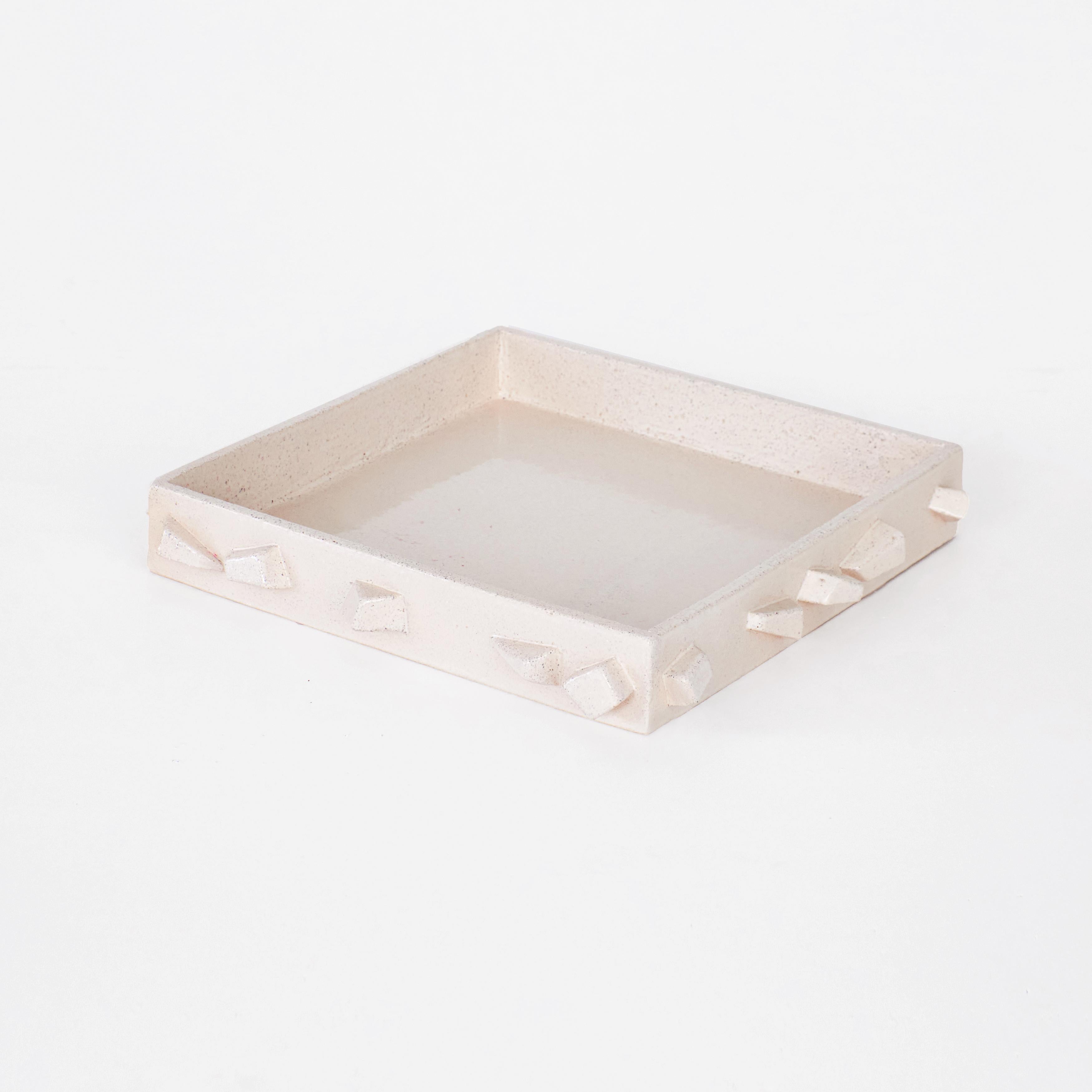 For Rachel tray in cream by Project 213A
Dimensions: D 33 x W 33 x H 5.5 cm
Materials: Ceramic. 

Hand-sculpted ceramic tray with hand made rectangle shaped elements. This large sized tray is finished with a bespoke cream glaze that reveals the