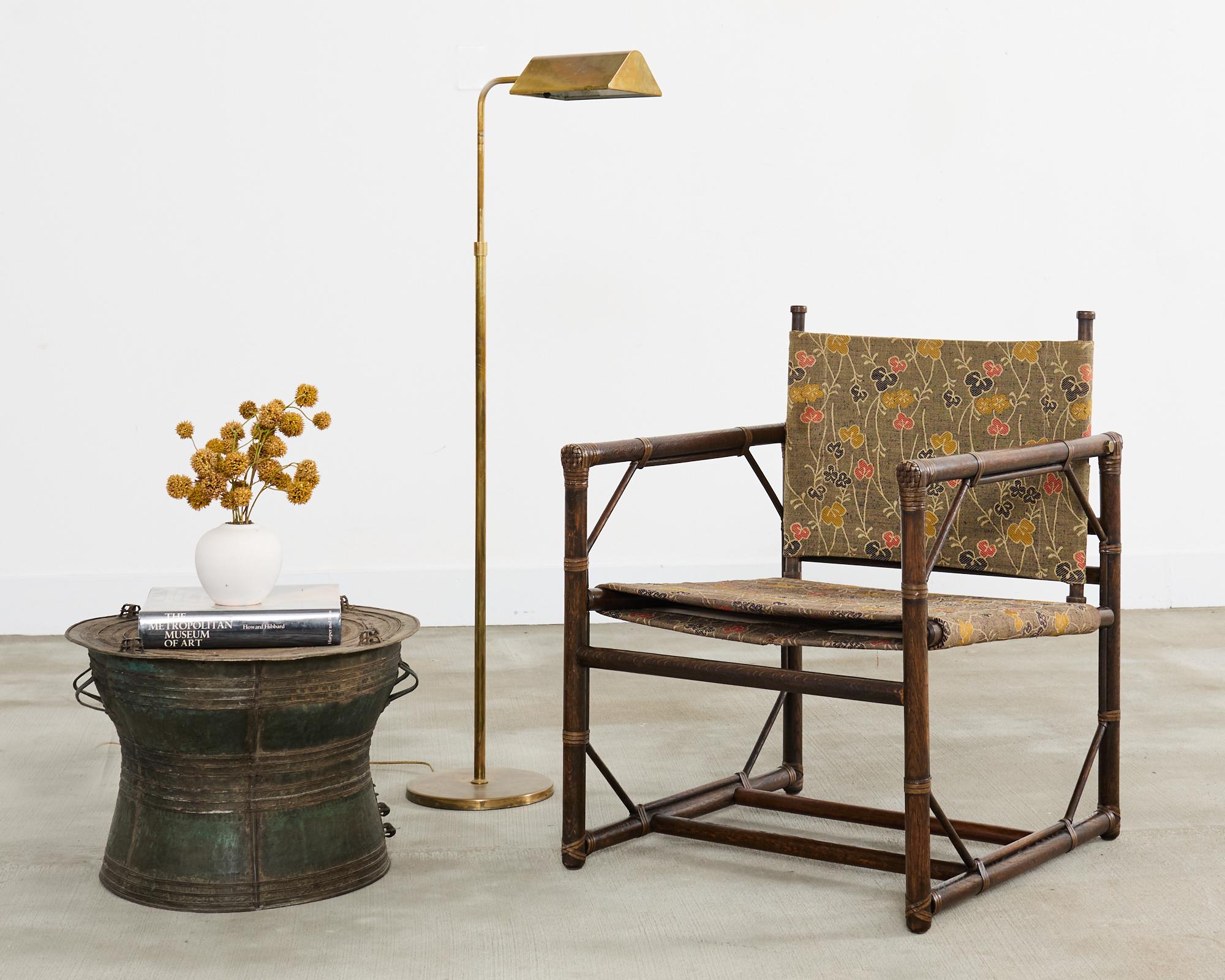 Rare campaign style officer's chair or sling chair designed in the mid-century by Eleanor Forbes for McGuire. The chair features a cube-shaped oak frame reinforced with leather rawhide laces on the exposed joints. The frame is fitted with two