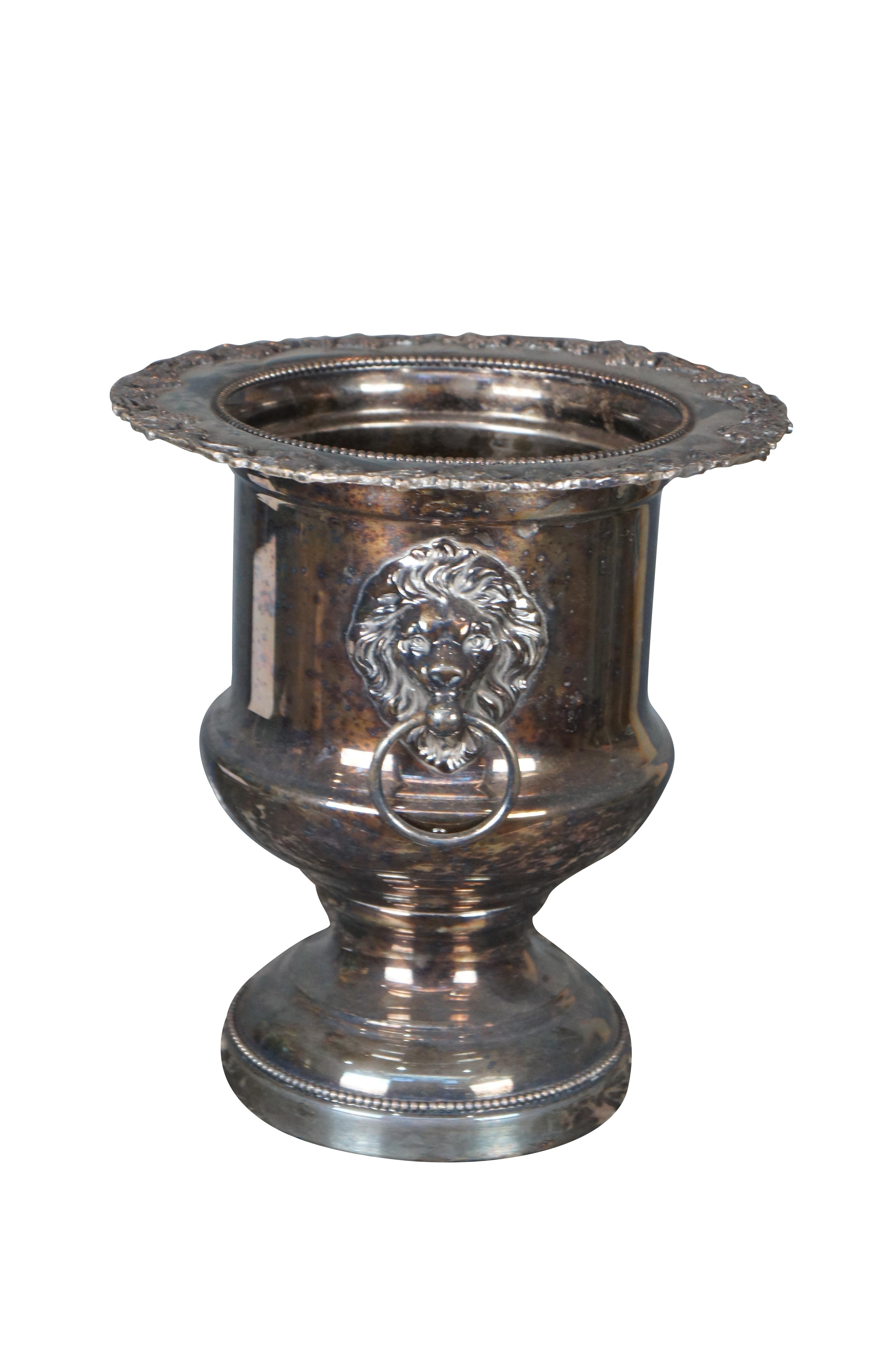 Georgian style wine / Champagne chiller by Forbes Silver company. Features a traditional form with figural lion knockers, a chased upper rim and ornate beading. 

FORBES SILVER CO - Meriden CT
organized in 1894 as a department of Meriden Britannia