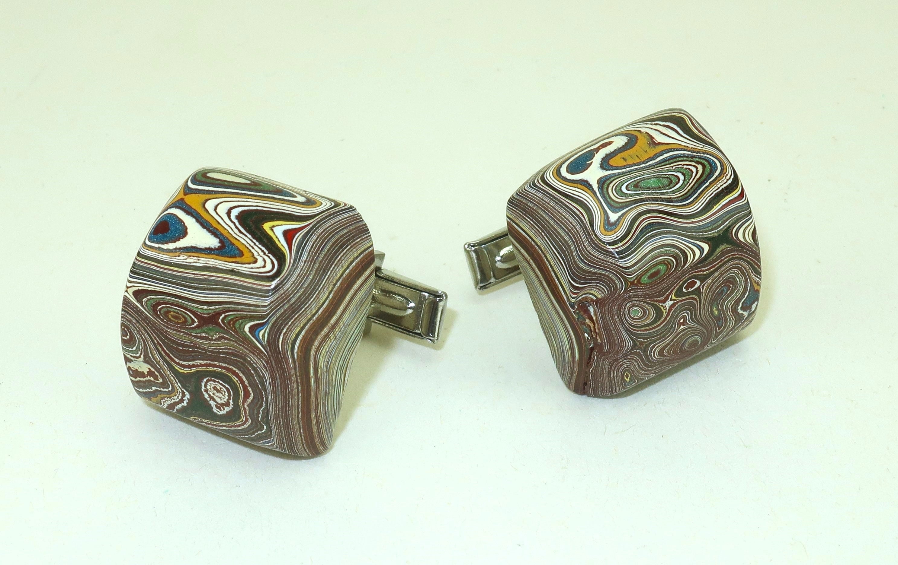 Straight from the motor city!  A pair of 1970's cufflinks created with a material dubbed as Fordite also known as ‘Detroit Agate’.  Though it looks like something organic created by Mother Nature, Fordite is actually polished layers of enamel paint
