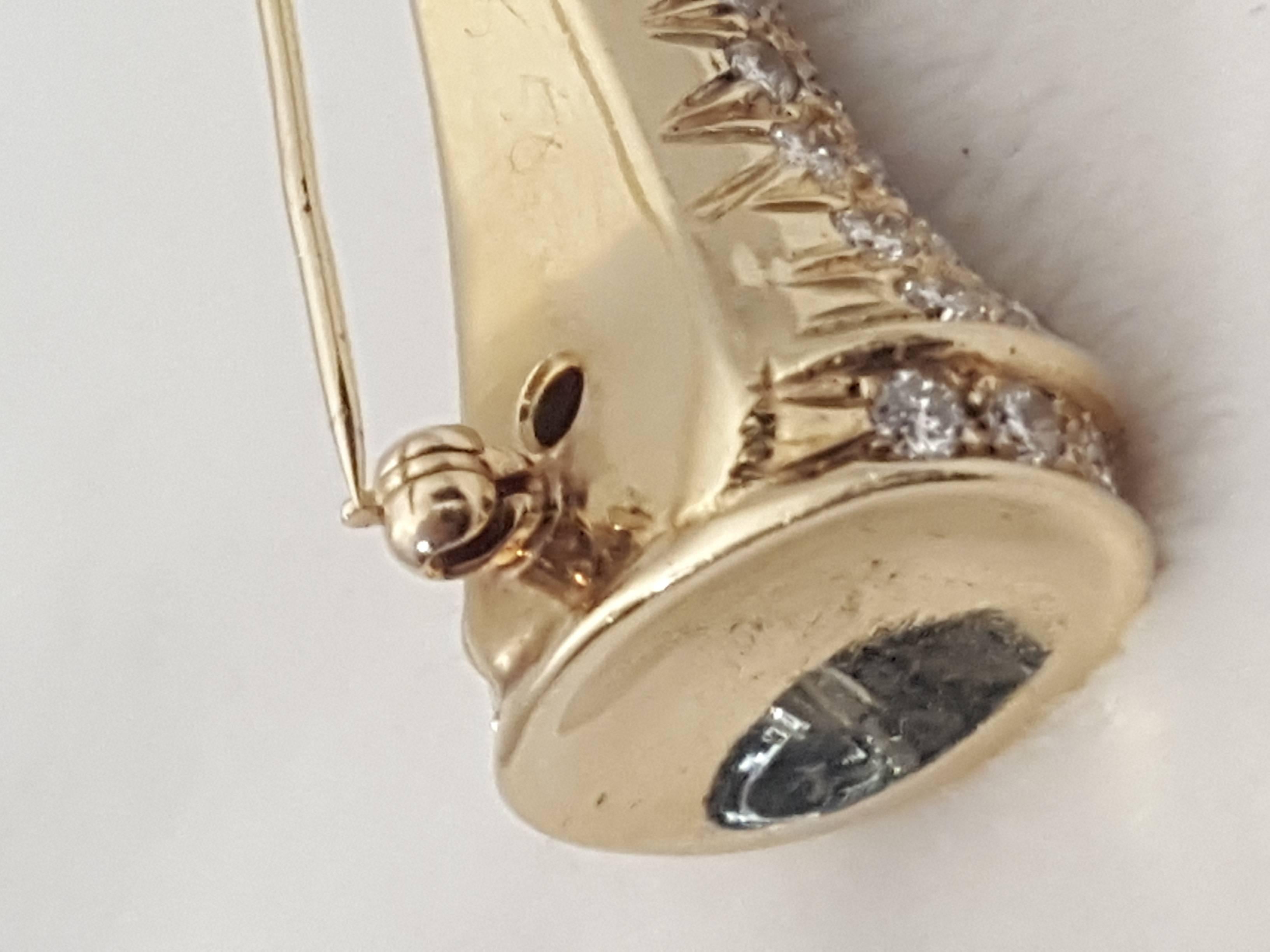 Better than a Green Jacket!  Lindsay & Co. manufactures such unique pieces! This Masters worthy golf tee brooch is encrusted in round white diamonds is meticulously crafted in 18 karat yellow gold.  Pointed end is high polish, curved high polish top