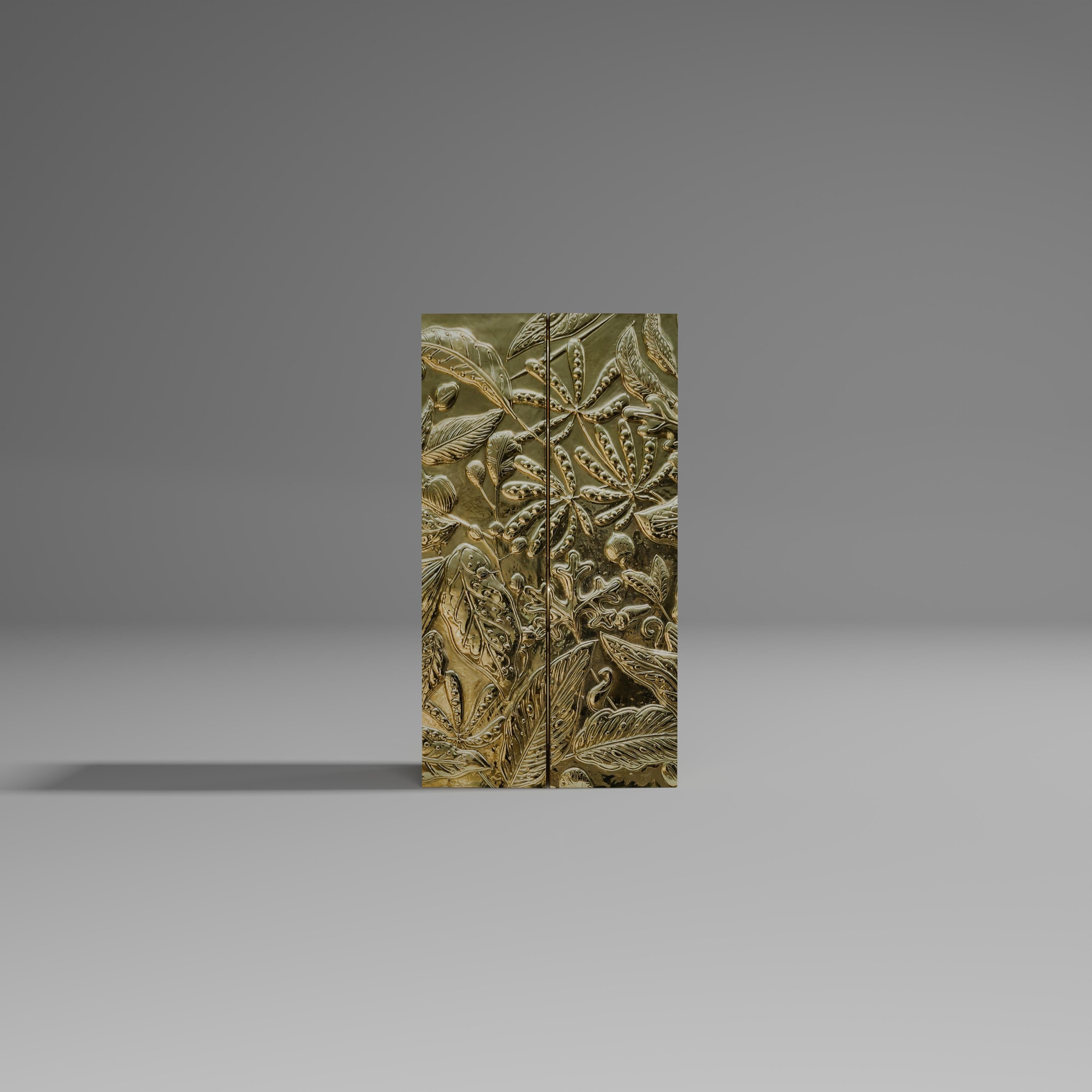 The Forest Bar is created in exquisite brass repousse with faux leather patterns in rich ivory resin on the inside. Brass trims complete the look. Transform your home with this elegant and timeless cabinet with drawers and shelves to house your
