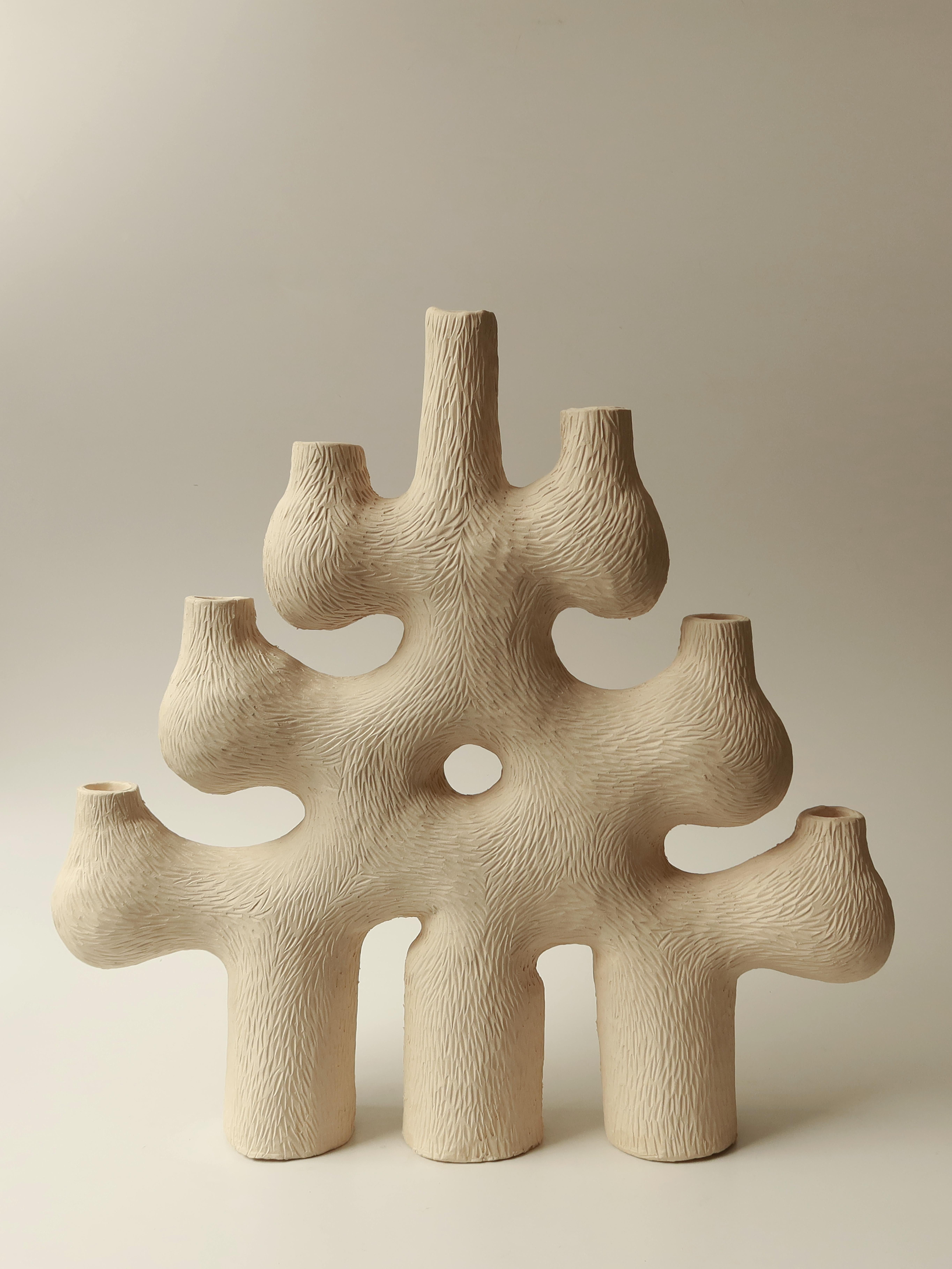 Forest Candelabra no.5 by Jan Ernst
Dimensions: W 55 x D 12 x H 52 cm
Materials: White stoneware, Black clay, Terracotta

Glazed to client specification.


Jan Ernst’s work takes on an experimental approach, as he prefers making bespoke