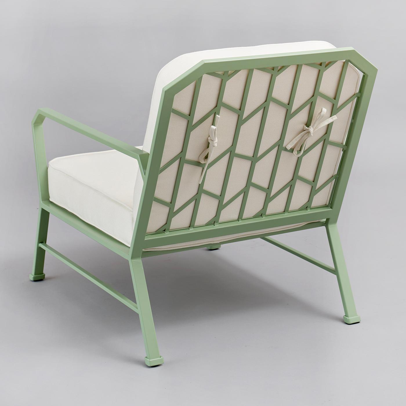 A modern terrace or garden will be delightfully complemented by this elegant armchair, its sculpted stainless steel frame powder-varnished in a delicate green tone (RAL 6021). Richly padded, the cushioned backrest and seat are covered in white