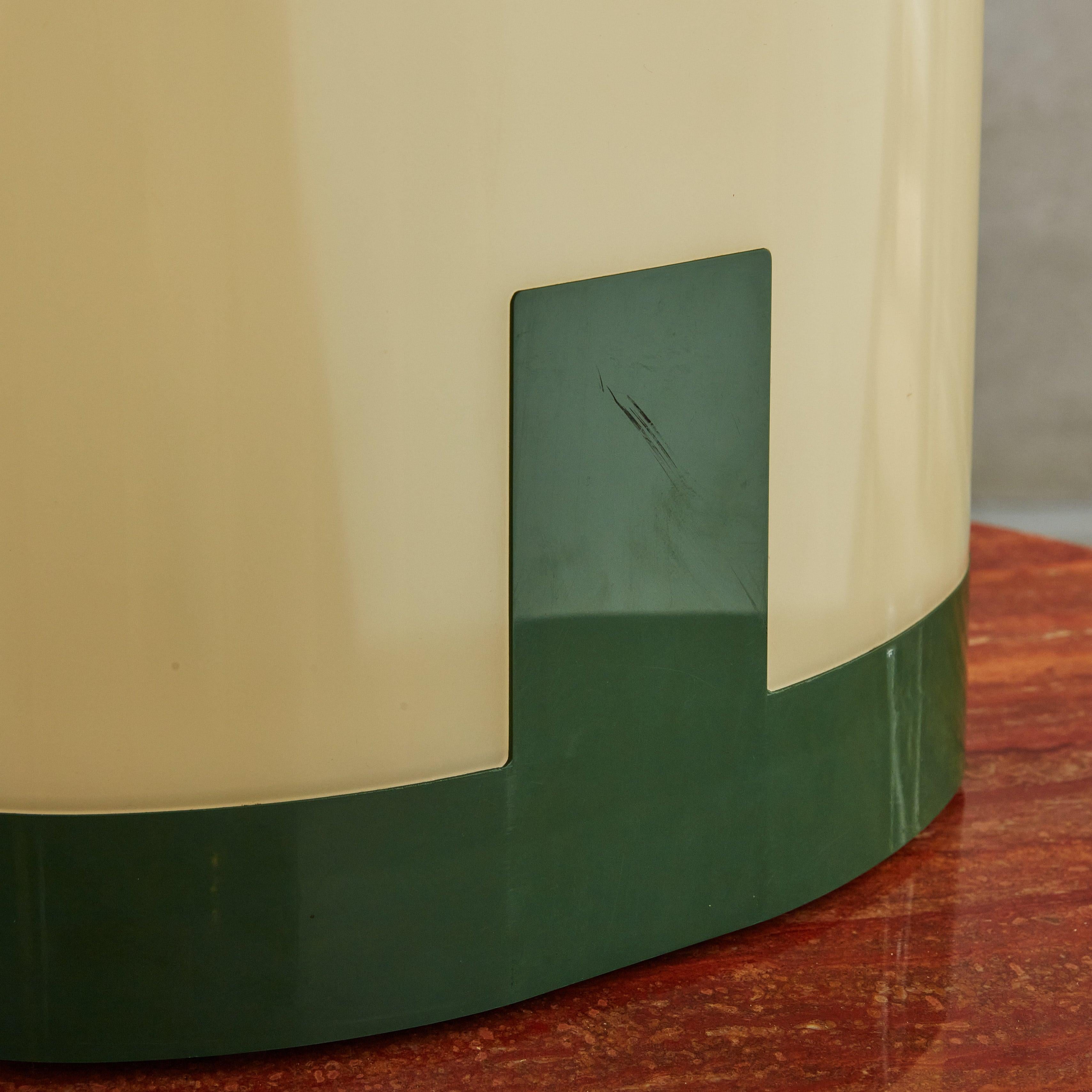This Postmodern, sculptural table lamp is constructed of forest green and transparent, cream hued acrylic. A warm glow is emitted when lit, beautifully highlighting an etched arch design that softly traces the domed silhouette. 5 available, priced