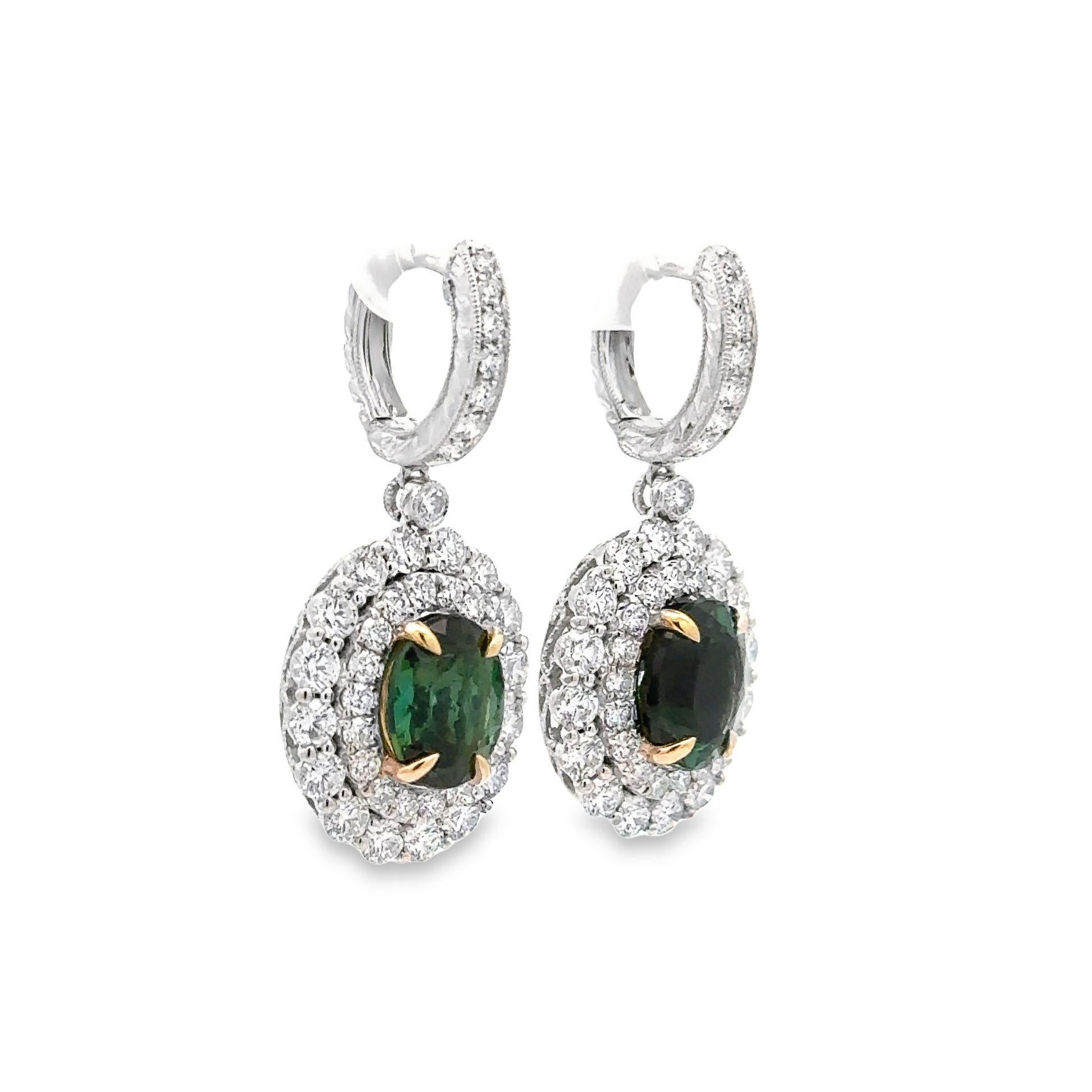 A pair of chic and elegant 18k white gold earrings featuring a pair of matching tourmalines. The tourmalines weigh a total of 4.90 carats and have a rich velvety forest green color with a hint of blue in it making it a unique and special color. They