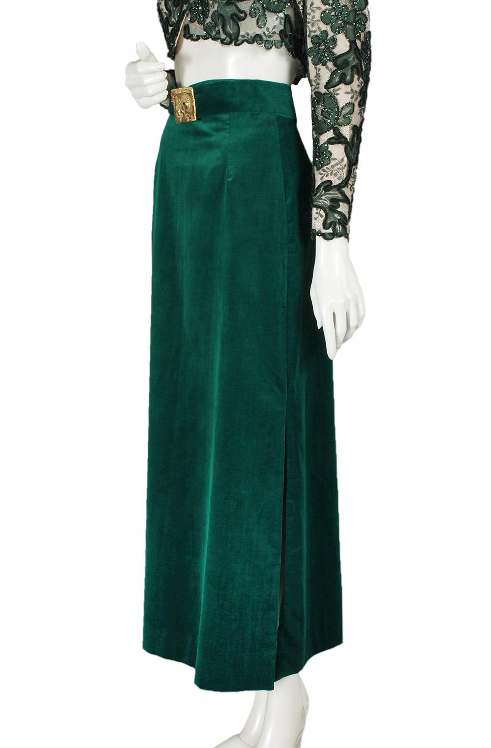 A retro holiday gem whose minimalist silhouette is punctuated by a bright gold Brutalist motif buckle that steals the show. Pair with a lime green Jell-O mold for kitsch or basic black for a Warhol Factory Girl twist.

Ankle-length column skirt with