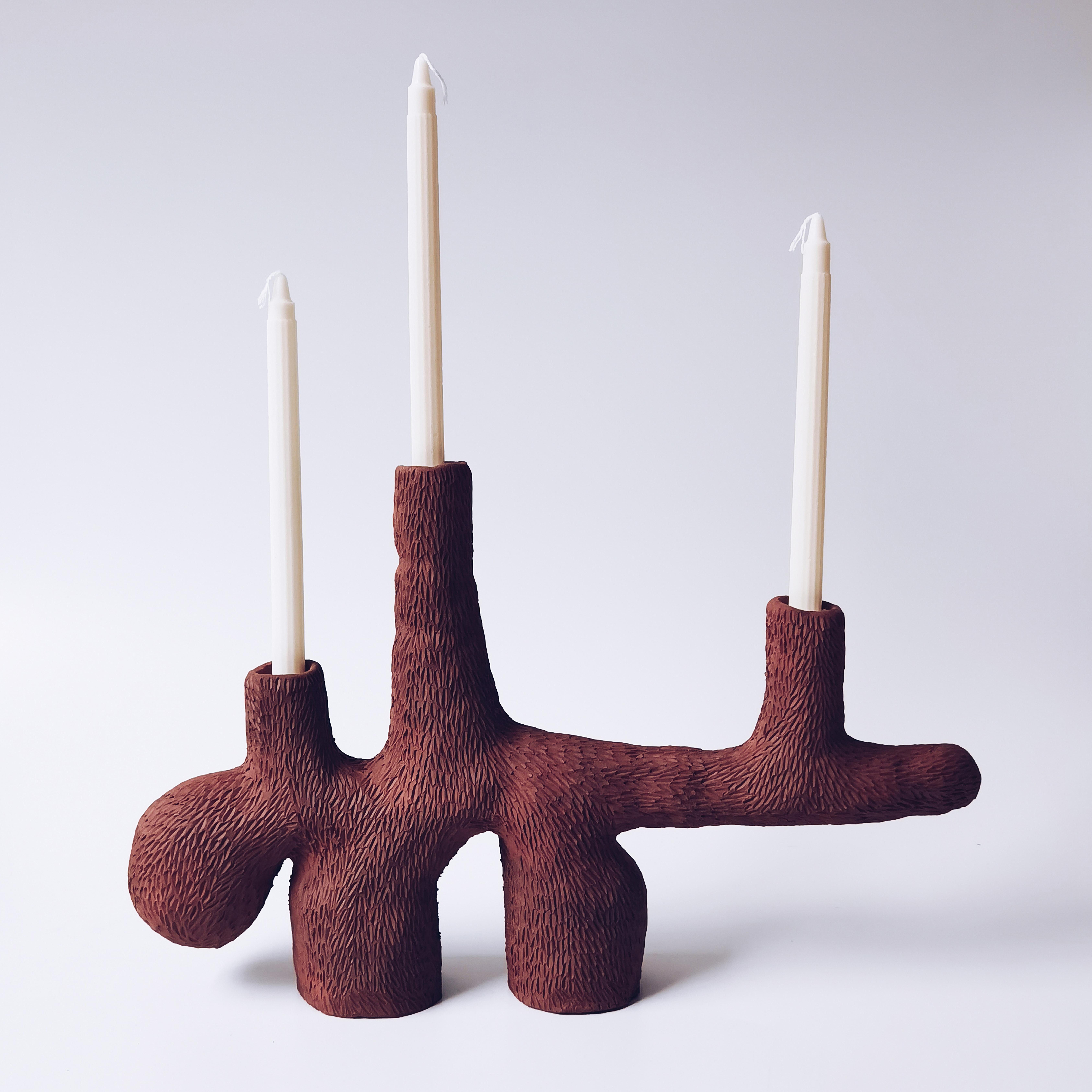 Forest terracotta candelabra by Jan Ernst
Dimensions: D48 x W 10 xH32 cm
Materials: Terracotta.
Also available: black clay / terracotta / white stoneware. 

Jan Ernst’s work takes on an experimental approach, as he prefers making bespoke pieces
