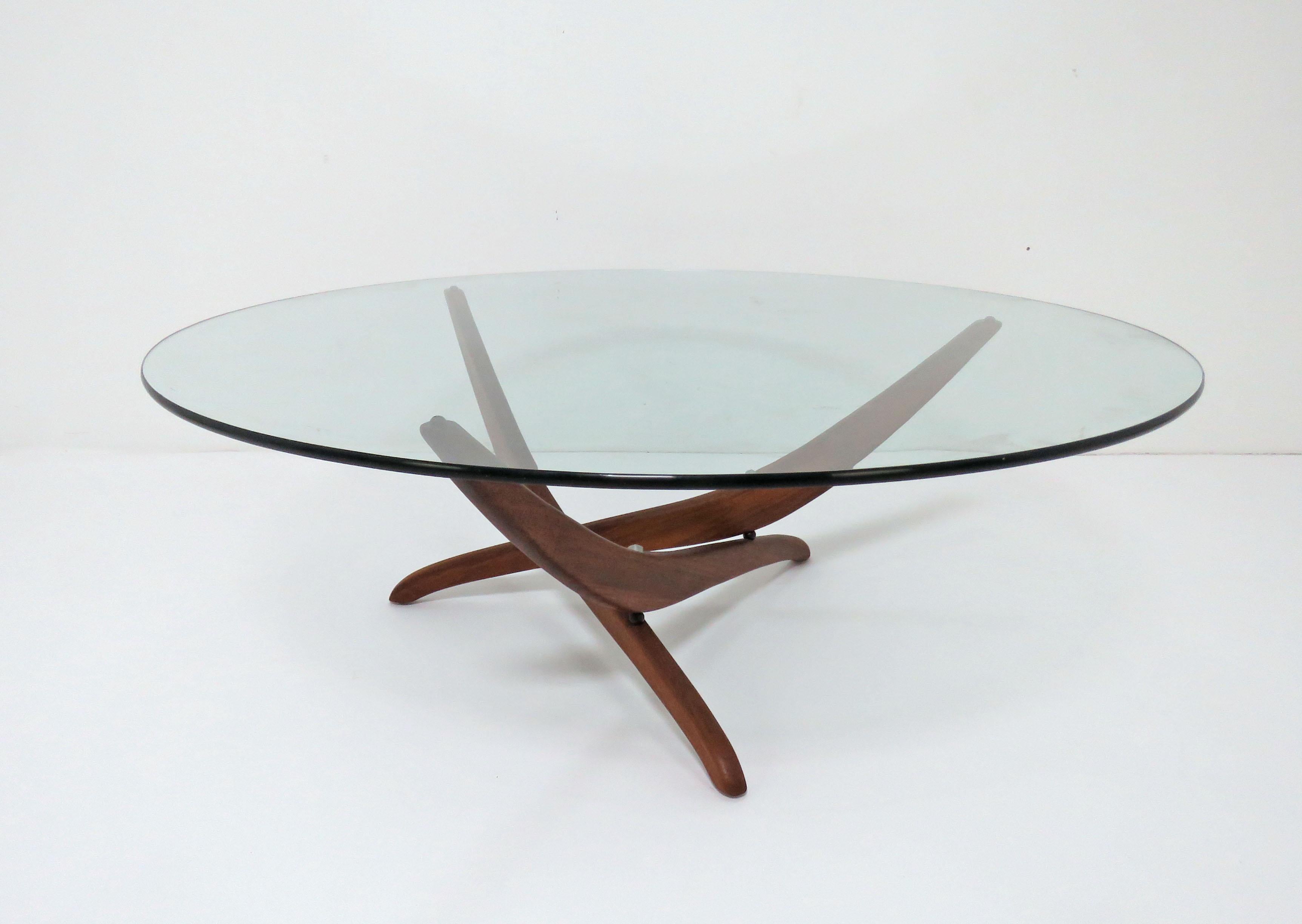 American coffee table in the Danish modern style, sculptural walnut base with aluminum fasteners, designed by Forest Wilson, circa 1960s.