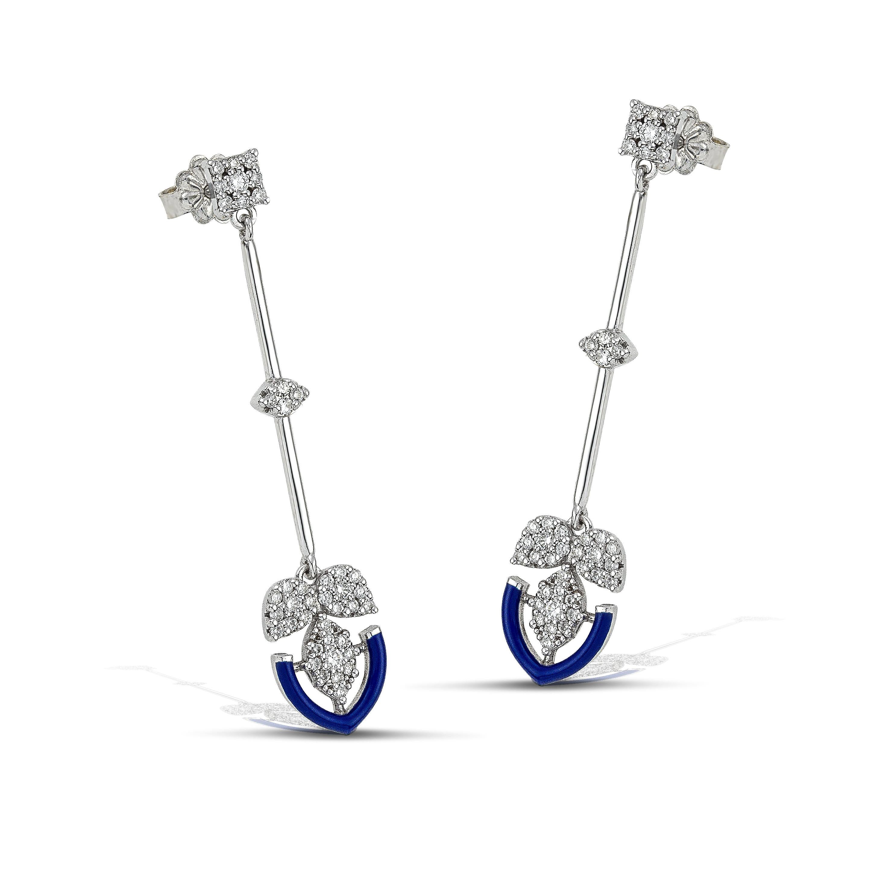 14K gold diamond earrings with a bold navy colour accent, the perfect gift for yourself or a loved one.
100% Recycled 14 K White Gold
Diamonds
Navy Enamel
Size: 5cm/1,96 inches
Inspiration: In the arts, maximalism, a reaction against minimalism, is