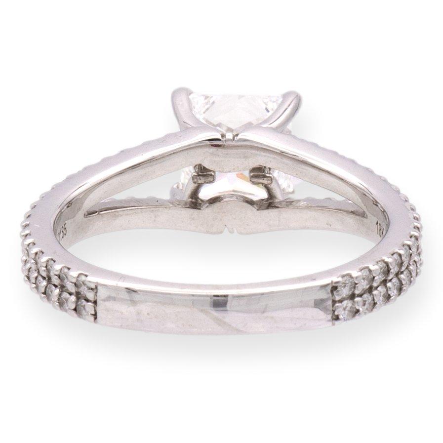 This is a beautifully crafted Forevermark by DeBeers Co. Devotion Princess Cut Diamond ring made of 18 Karat white gold with a split shank design. It features a stunning 1.52 carat princess cut diamond center stone, which has been graded F color and