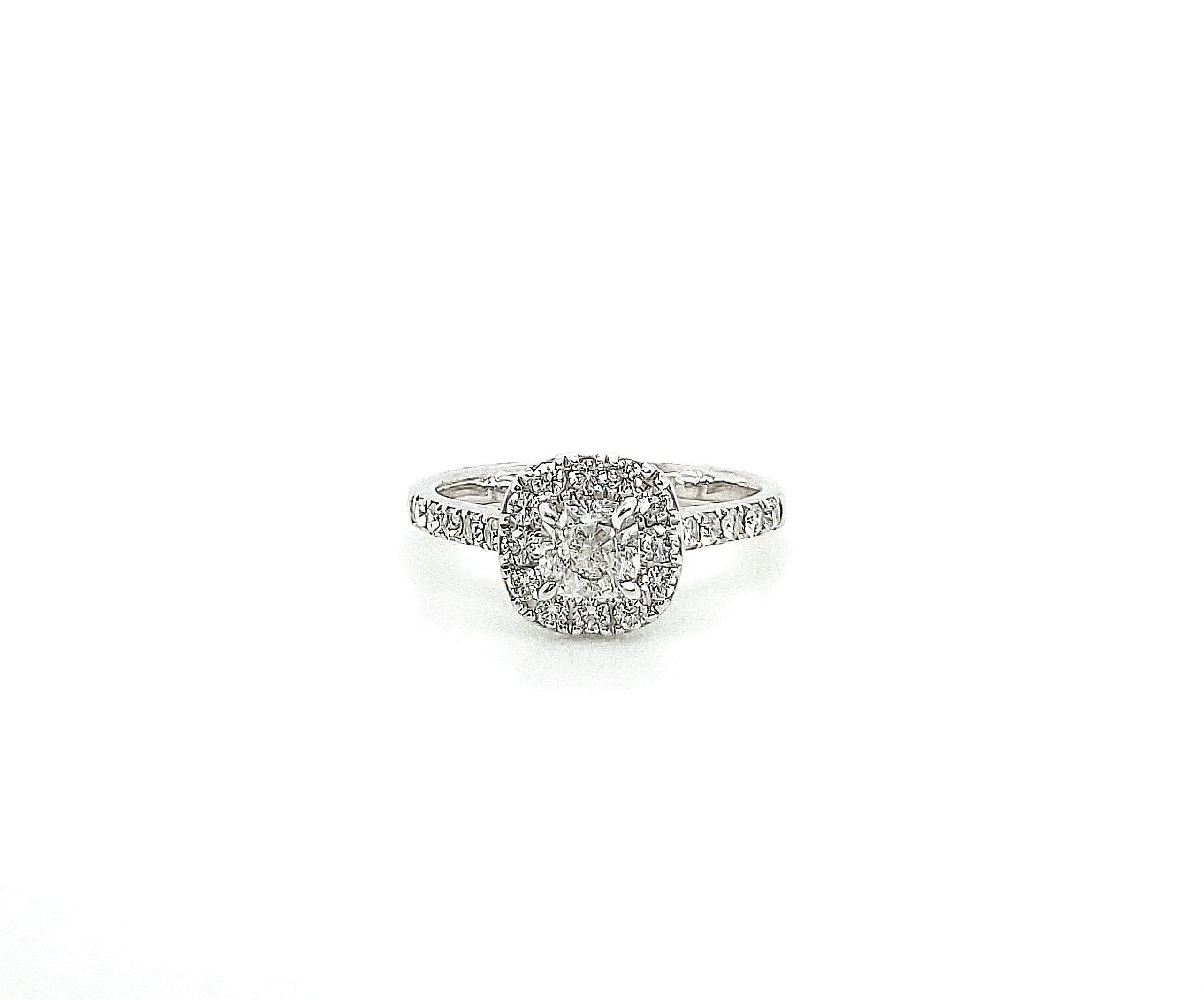 Forevermark diamond engagement ring made in platinum with a .51ct cushion modified brilliant center stone (E color, SI1 clarity) and a halo of approximately 12 round brilliant diamonds with approximately 10 additional diamond on the band.  Ring is