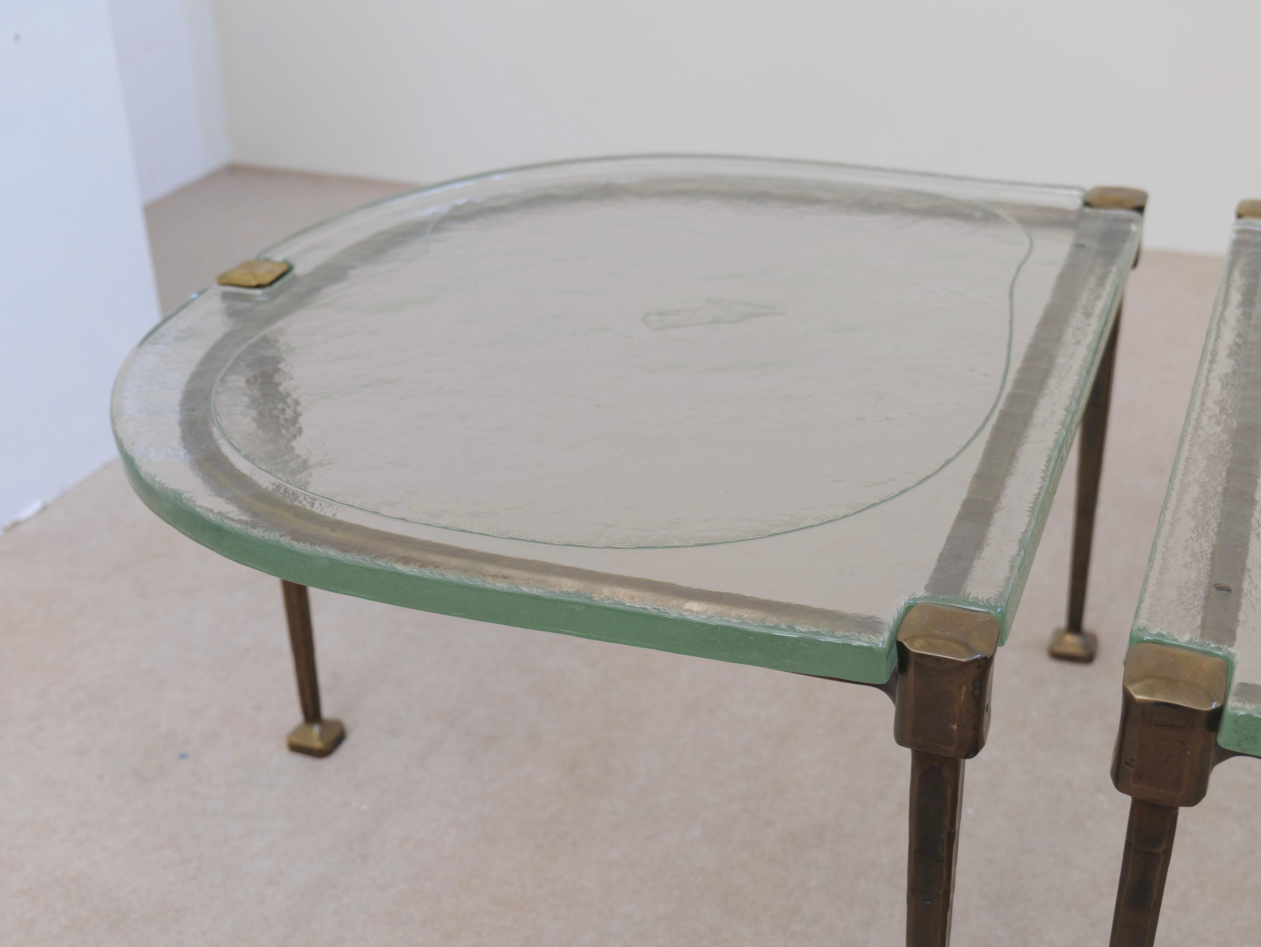 Cast forged bronze coffee tables by Lothar Kute with green glass For Sale