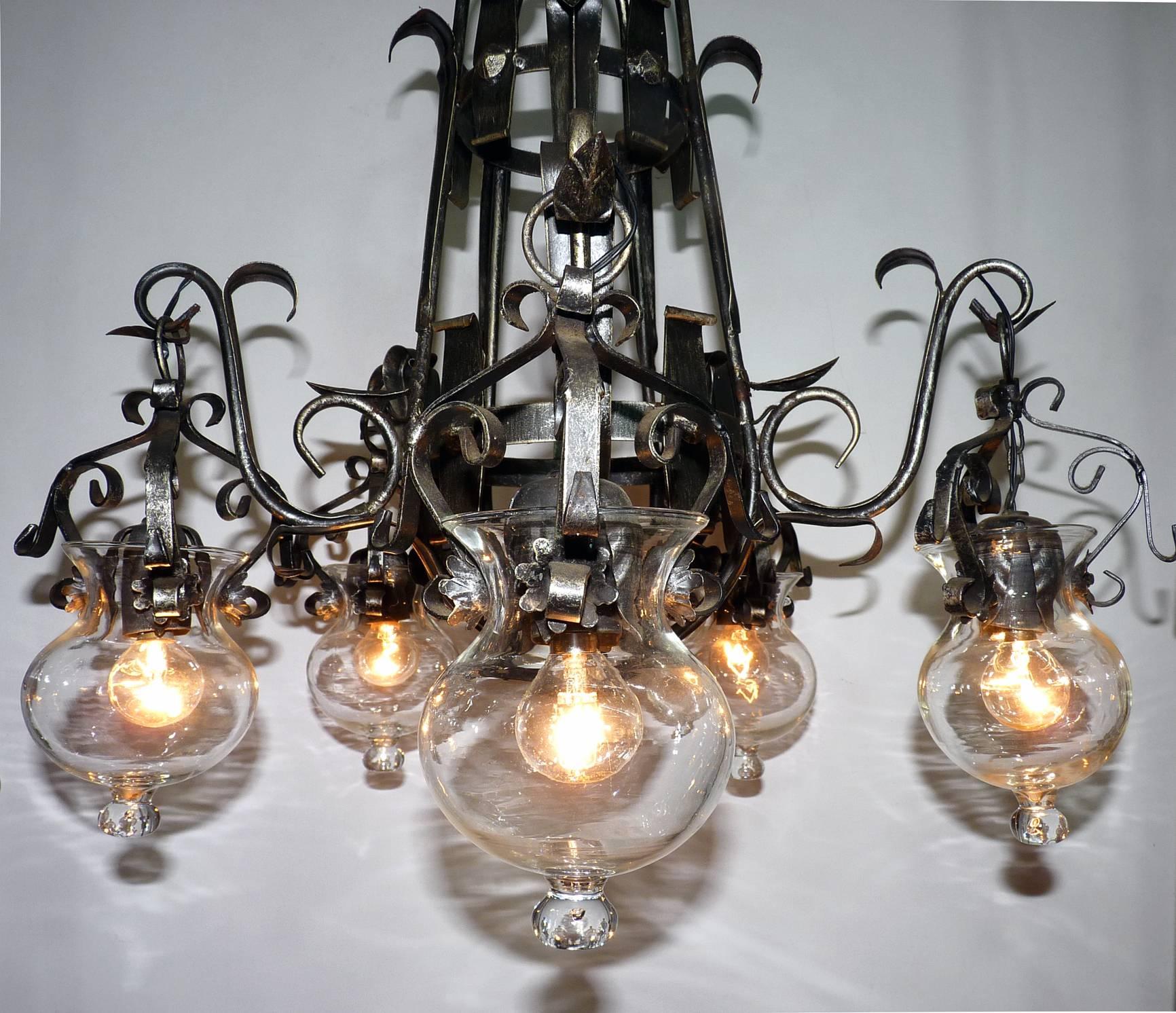 Unusual French forged iron and tole cage-form chandelier with five-hanging light glass globes. Black color in a silver finish. Original hand blown clear glass globes with tear drop.
Measures:
Diameter 28 in / 70 cm
Height 28 in / 70 cm
Weight 13 lb.
