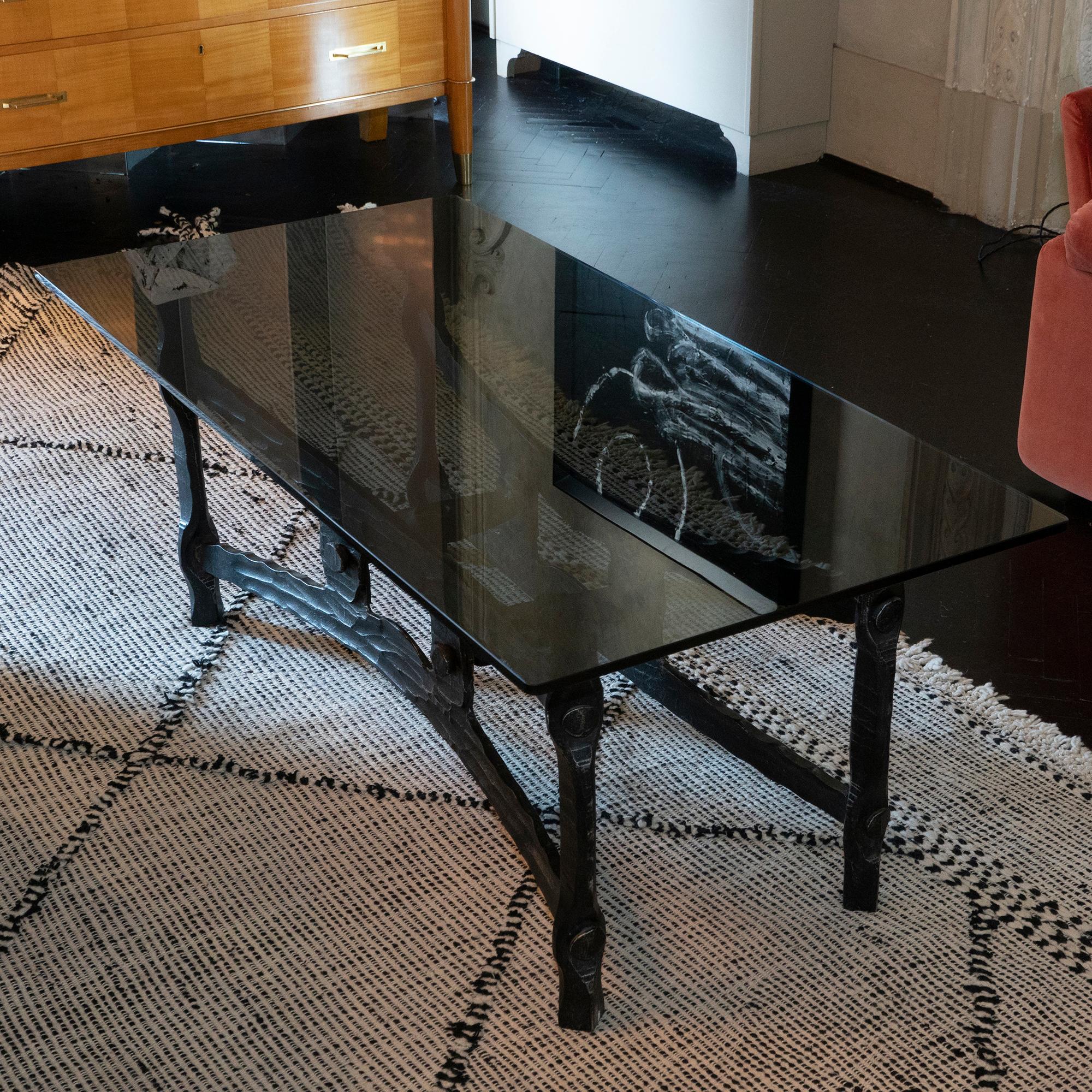 Forged and hammered iron coffee table base, new smoked glass top, France, 1940s.
 