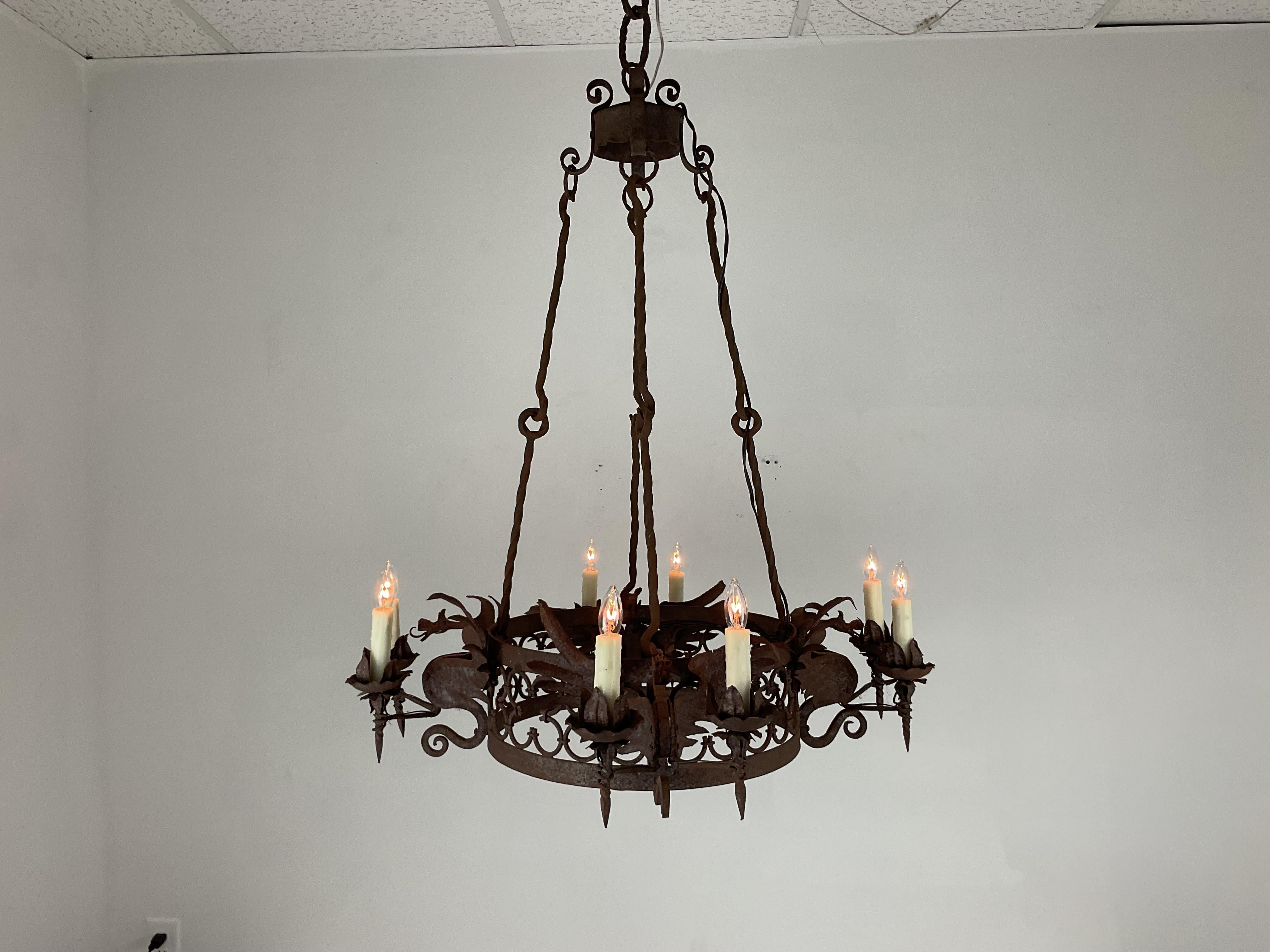 Incredibile lampadario a forma di drago in ferro forgiato a mano. Squisiti draghi di ferro dettagliati su telaio in ferro forgiato. Stile mediterraneo. Insolito e drammatico. Otto luci completamente ricablate con prese a candelabro americane. Viene