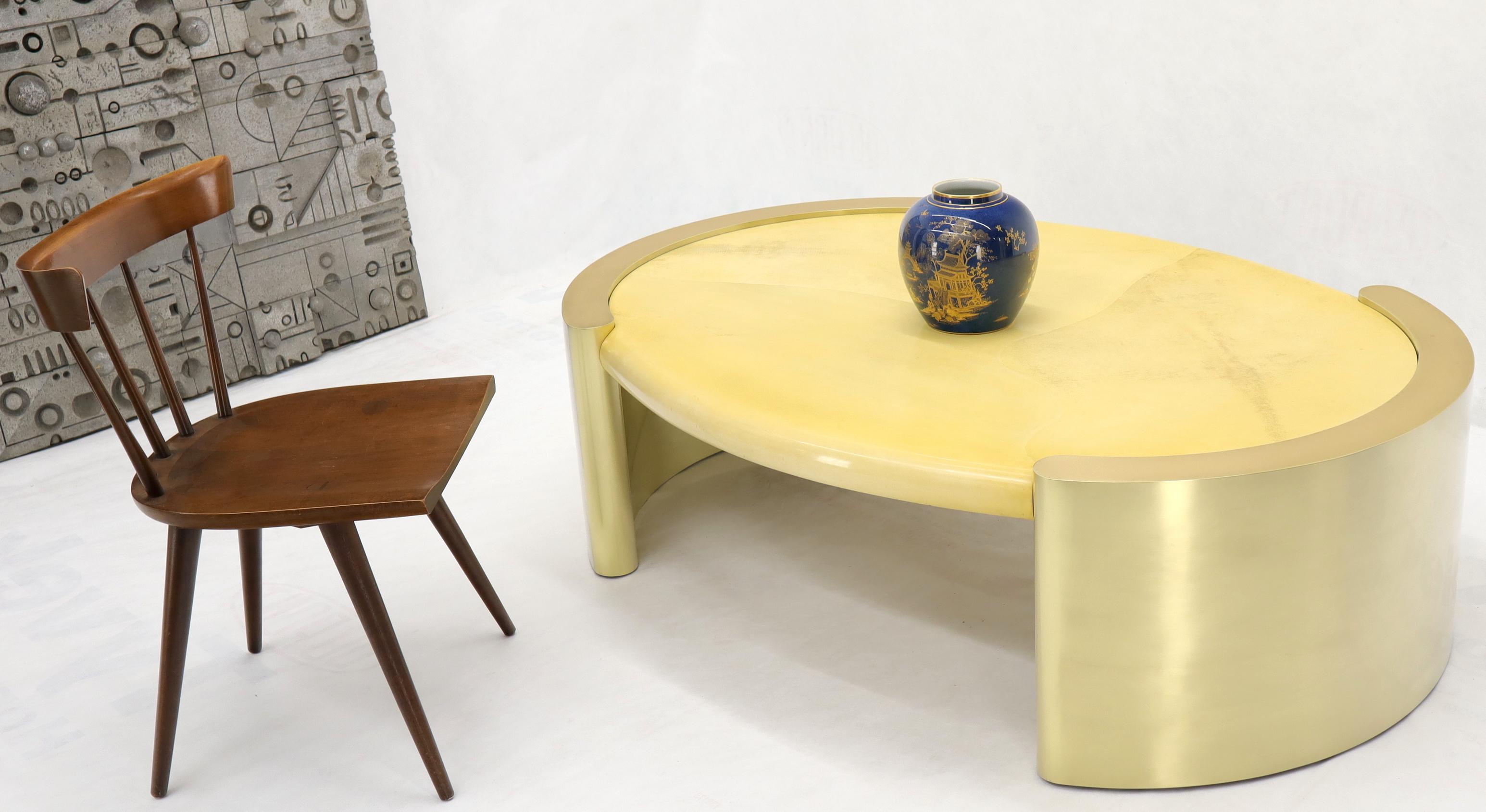 Massive oval coffee table consisting of forged brass bases and lacquered goatskin parchment top. Matches Karl Sptinger decor and possibly designed by him. Unsigned.