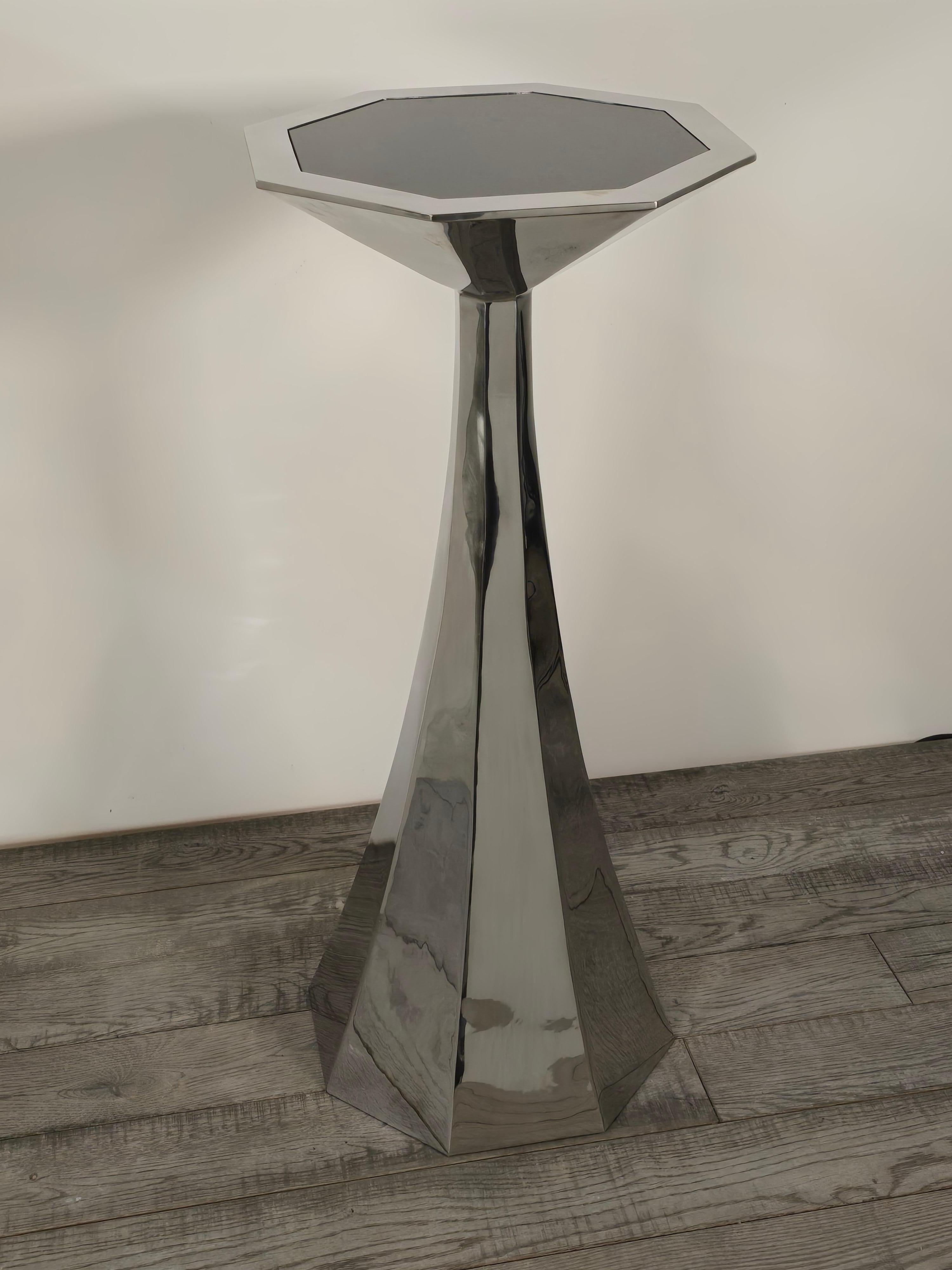 Stunning forged stainless steel console with inset black granite top hand forged by artist Curtis Norton in 2022.  The octagonal base slowly tapers in a curve from the base to the top where changes to a knife edge style pedestal top.    One of a