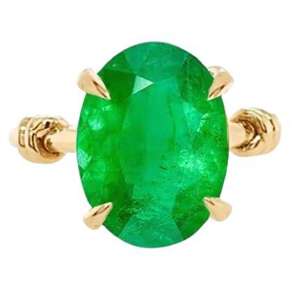 For Sale:  Forget Me Knot Oval Cut Emerald Ring 1 Carat in 18 Carat Yellow Gold